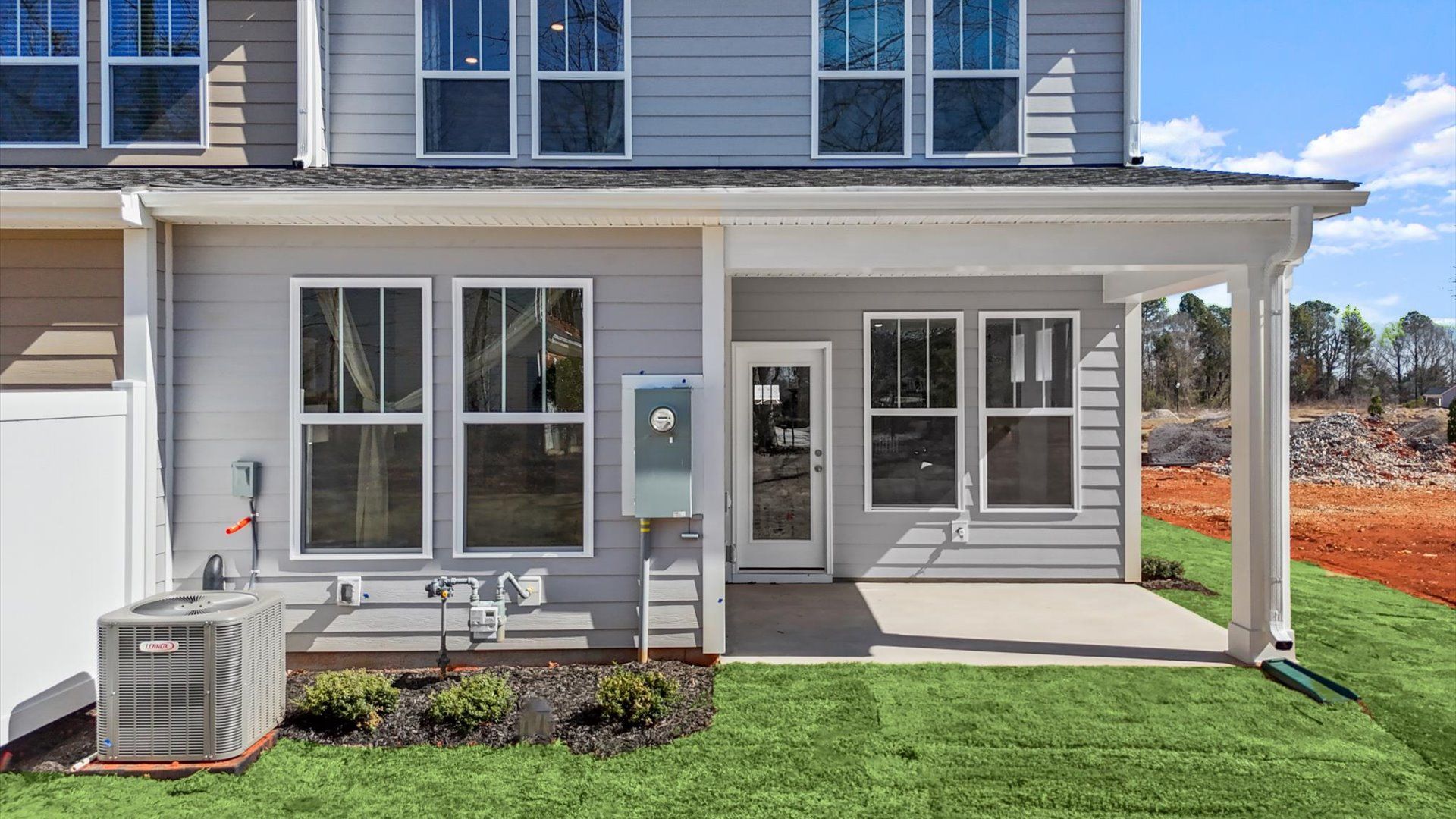 Exceptional outdoor living begins with a covered back porch in this thoughtfully designed villa at Pelham Crossing