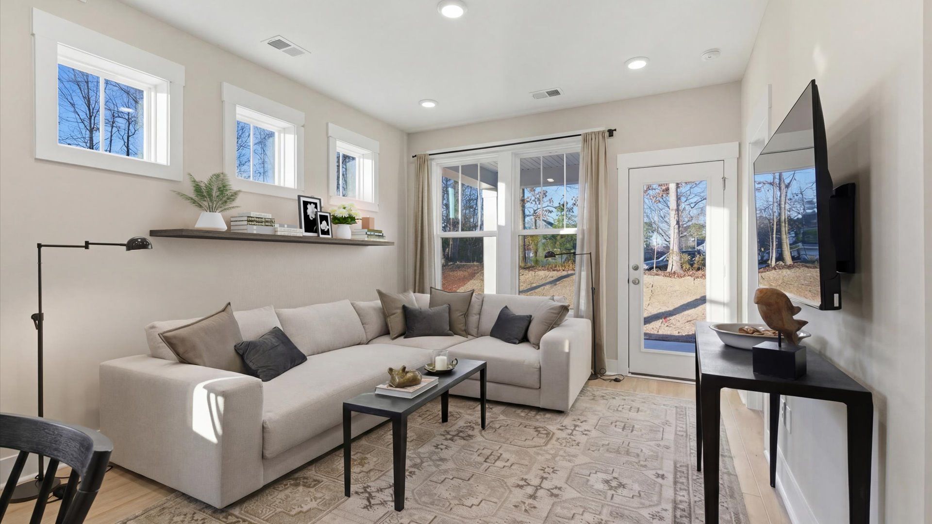 Memorable moments begin in this elegant, open family room with hardwood flooring and refined finishes in Greenville, SC