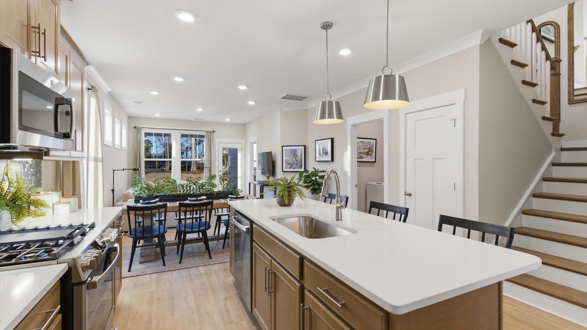 Highly skilled kitchen design includes a 9-foot island, quartz countertops, and stylish pendant fixtures at Pelham Crossing