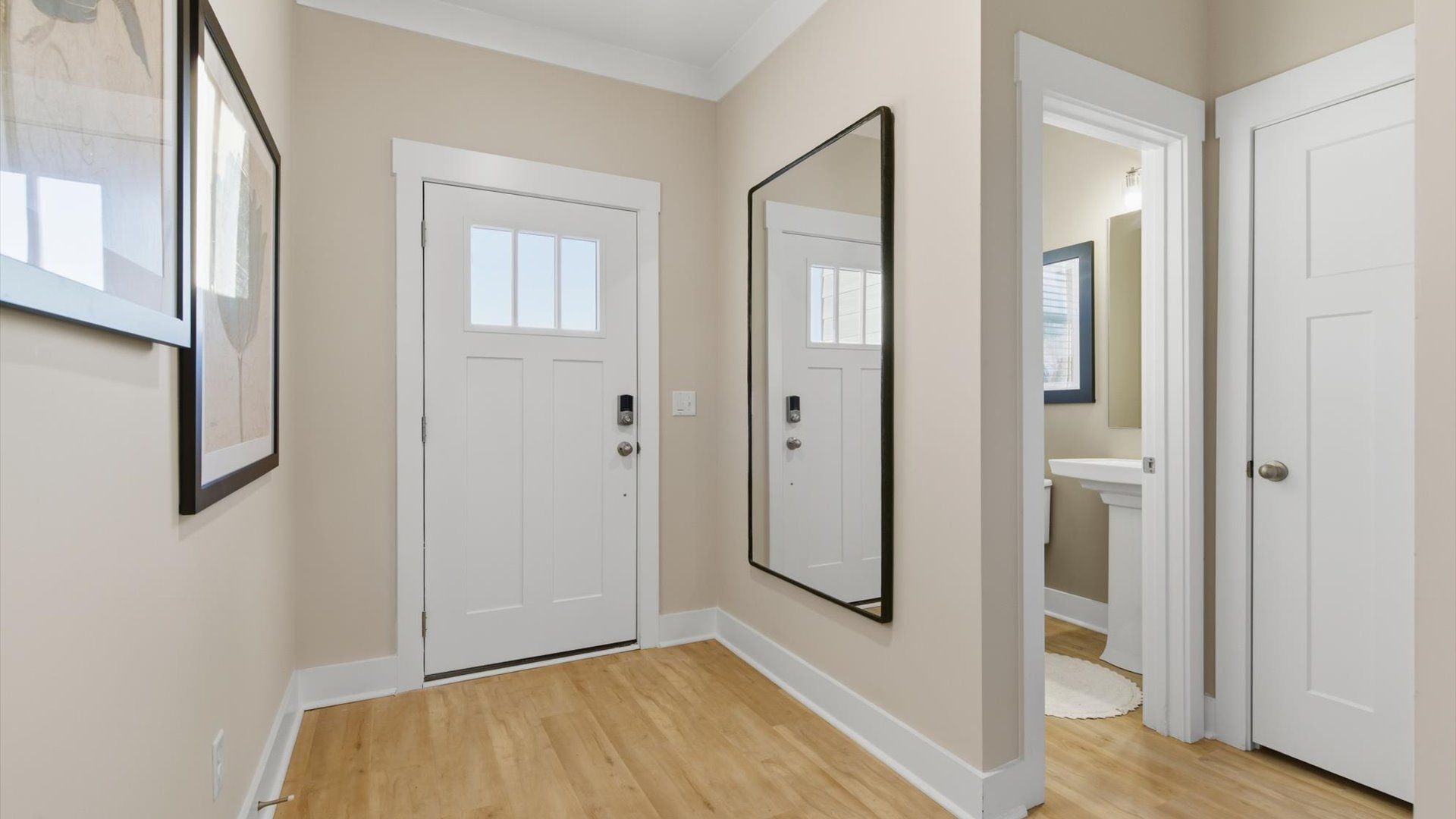Accomplished hardwood flooring foyer sets the tone for tasteful design throughout the villa at Pelham Crossing