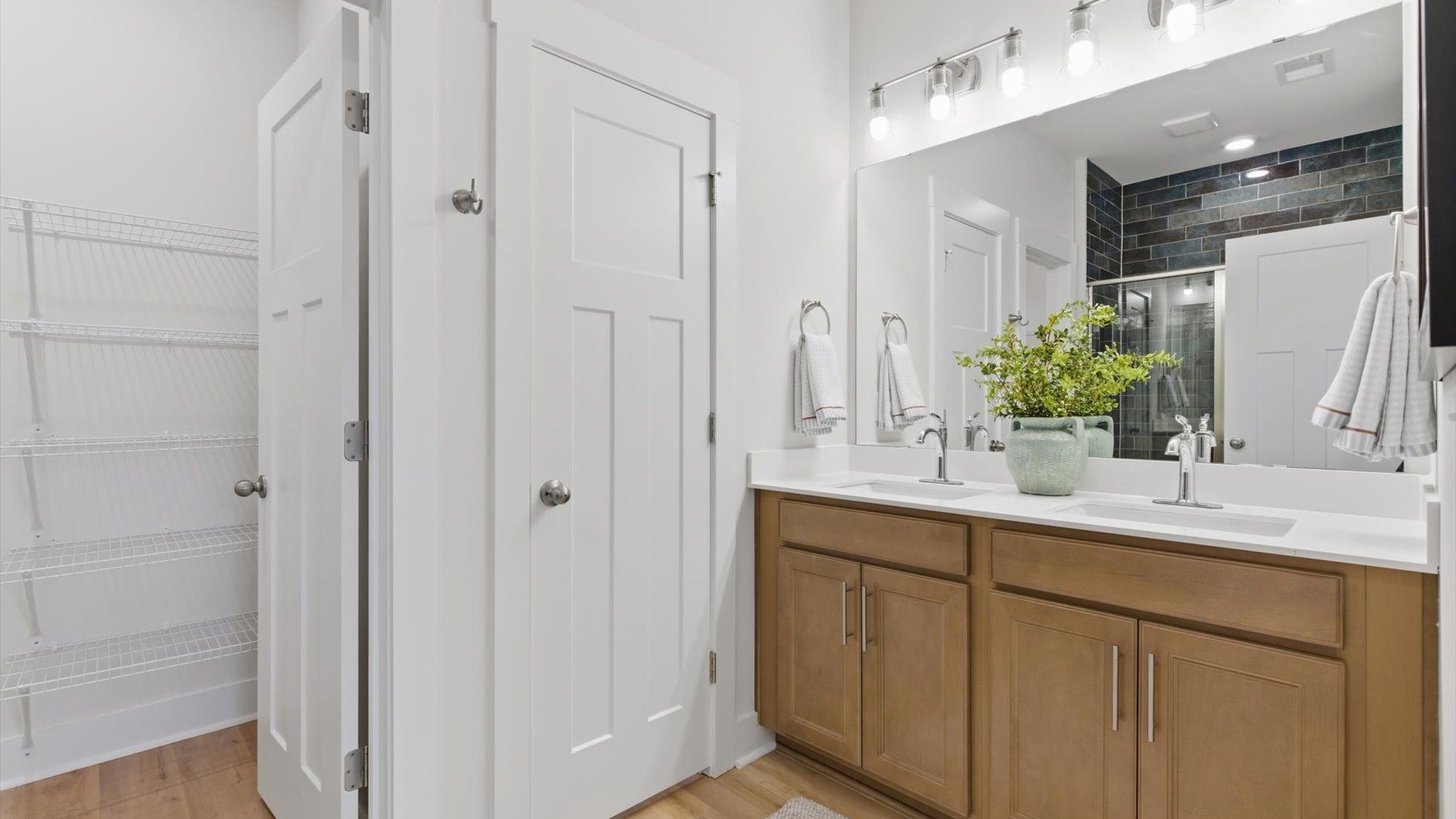 Notable primary suite with dual vanities and walk-in shower in this prime Greenville villa at Pelham Crossing