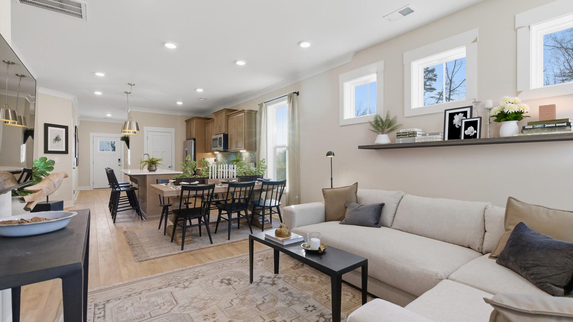Vibrant and welcoming family room anchored by clean lines, tasteful materials, and abundant light