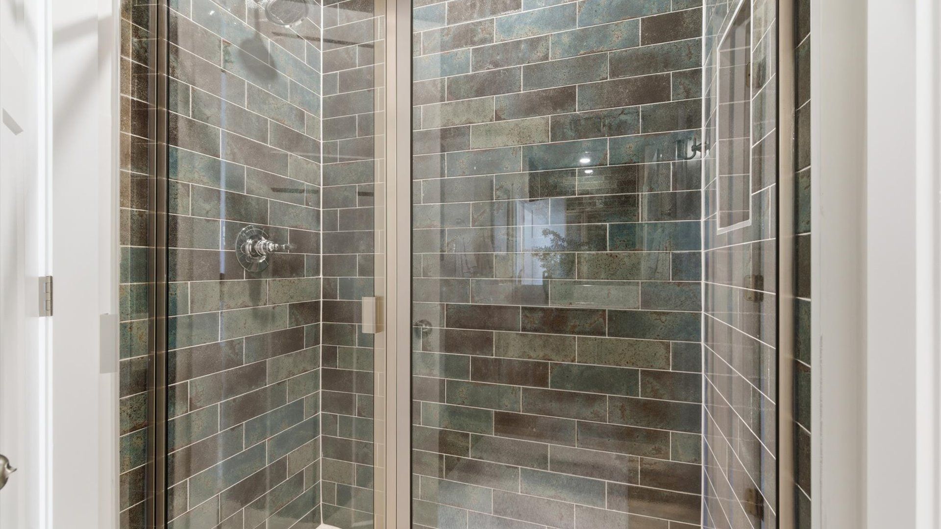 Superior en-suite primary bathroom with a stylish walk-in shower—crafted with high standards in mind