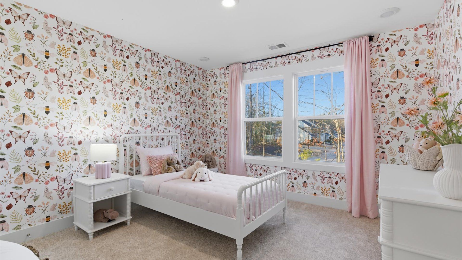 Bright and serene bedroom with comfortable carpeted flooring and large windows for vibrant light at Pelham Crossing Villas
