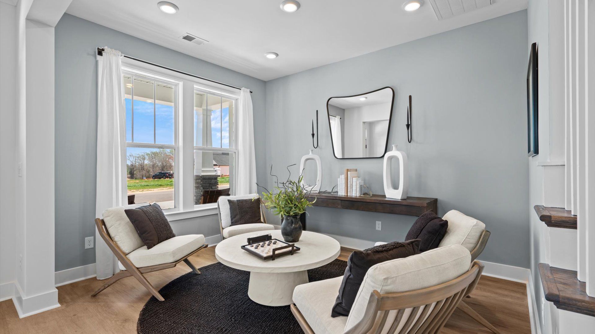 Superior design shines in this open-concept living room with timeless finishes and a modern edge