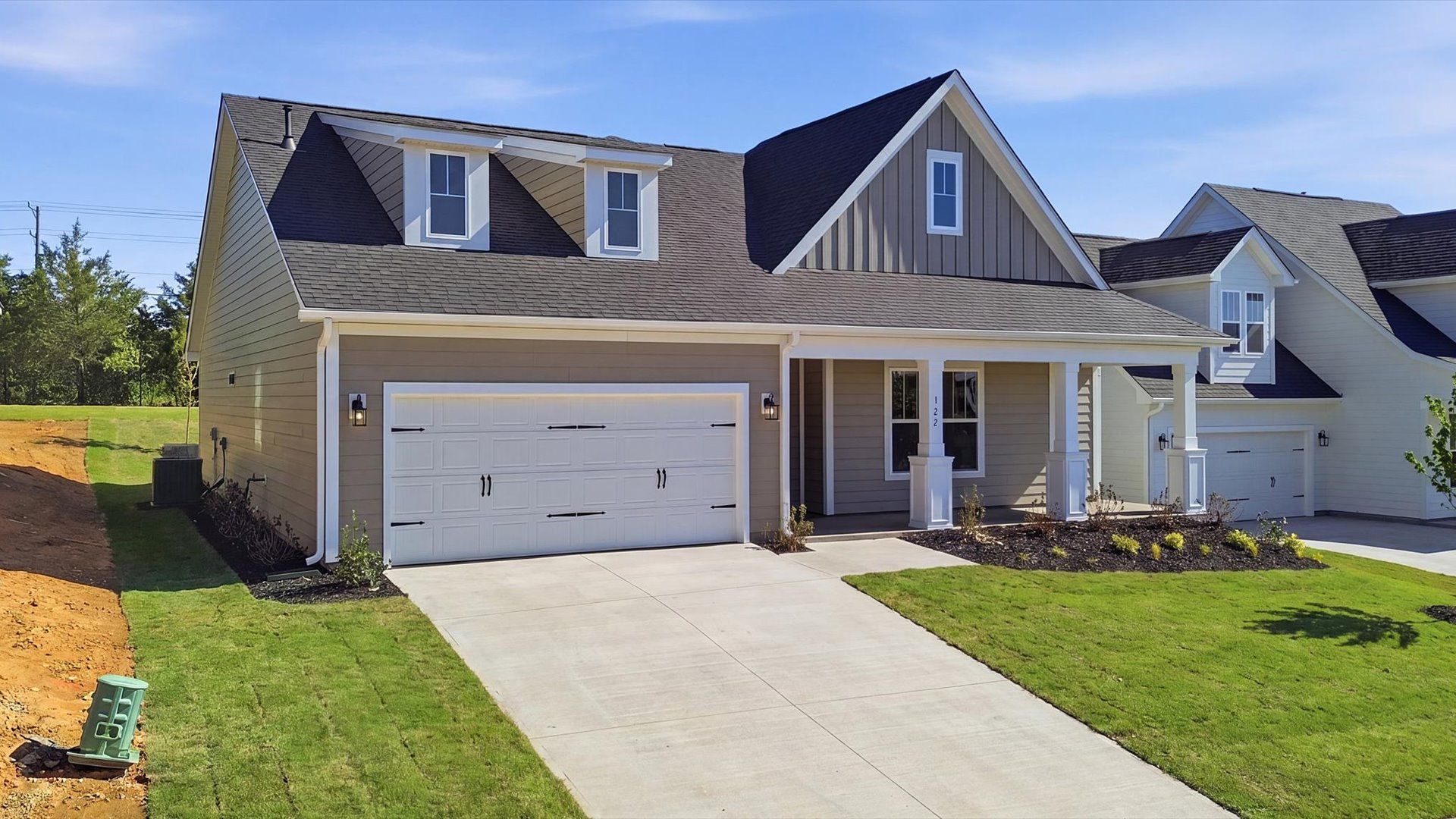 Well-appointed exterior featuring warm tones and designer-selected finishes located at the Benjamin's Grove community