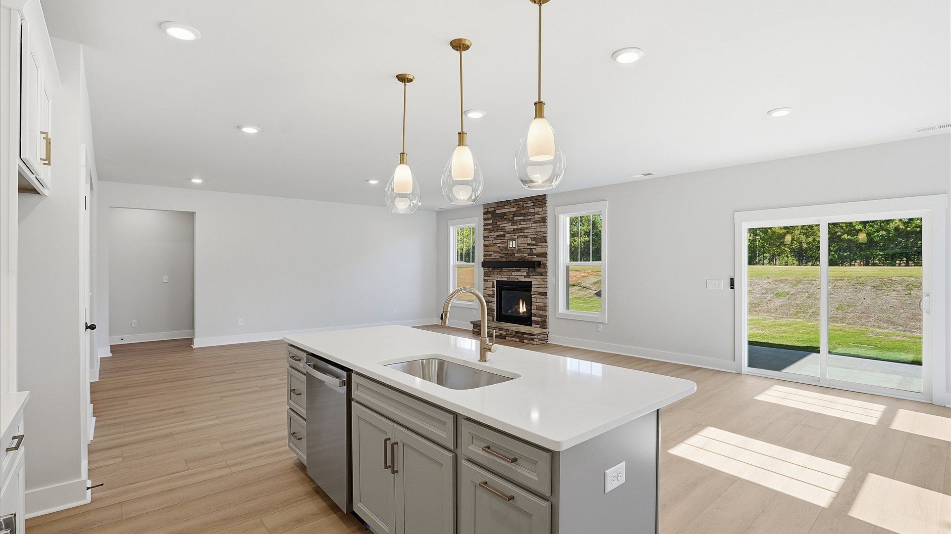 Accomplished kitchen design featuring pendant lighting above a statement island for both prep and gathering in Woodruff, SC