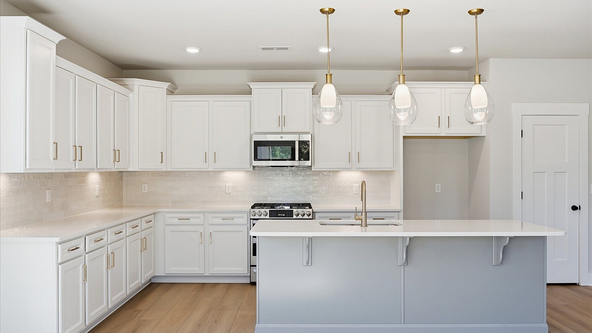 Notable kitchen space with elegant pendant lighting and a large island perfect for entertaining at Benjamin's Grove