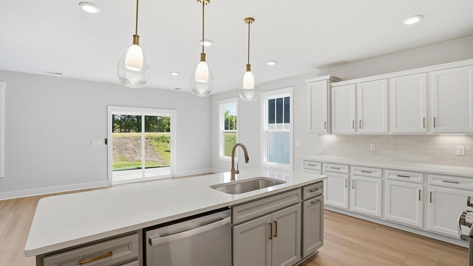 Memorable meals begin in this vibrant kitchen with pendant lighting and a thoughtfully designed island