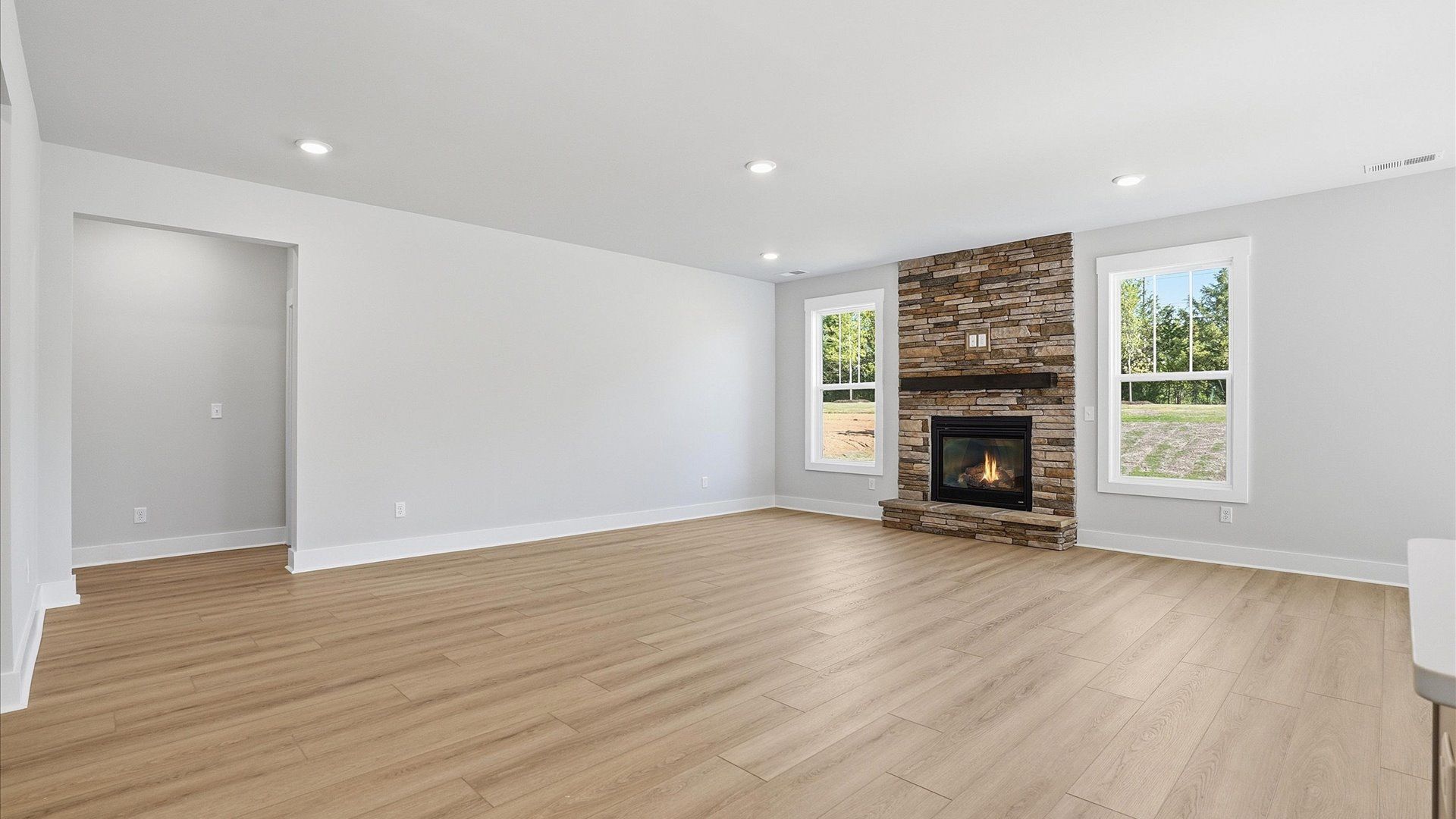 Exceptional family space with hardwood floors and seamless flow to dining and kitchen areas located at Benjamin's Grove