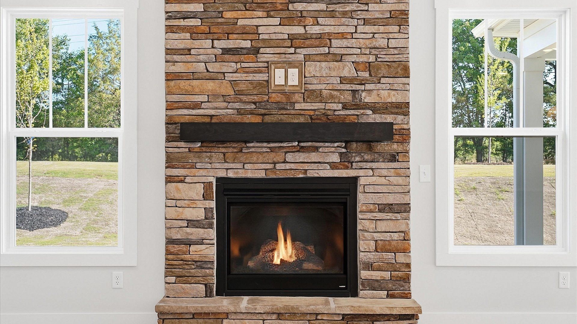 Superior design shines in this open-concept family room with a stone fireplace, timeless finishes and a modern edge in SC