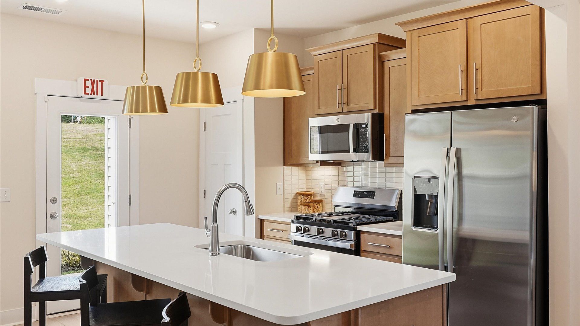 Highly skilled design choices create a clean, open kitchen with a central island in this townhome at El Dorado