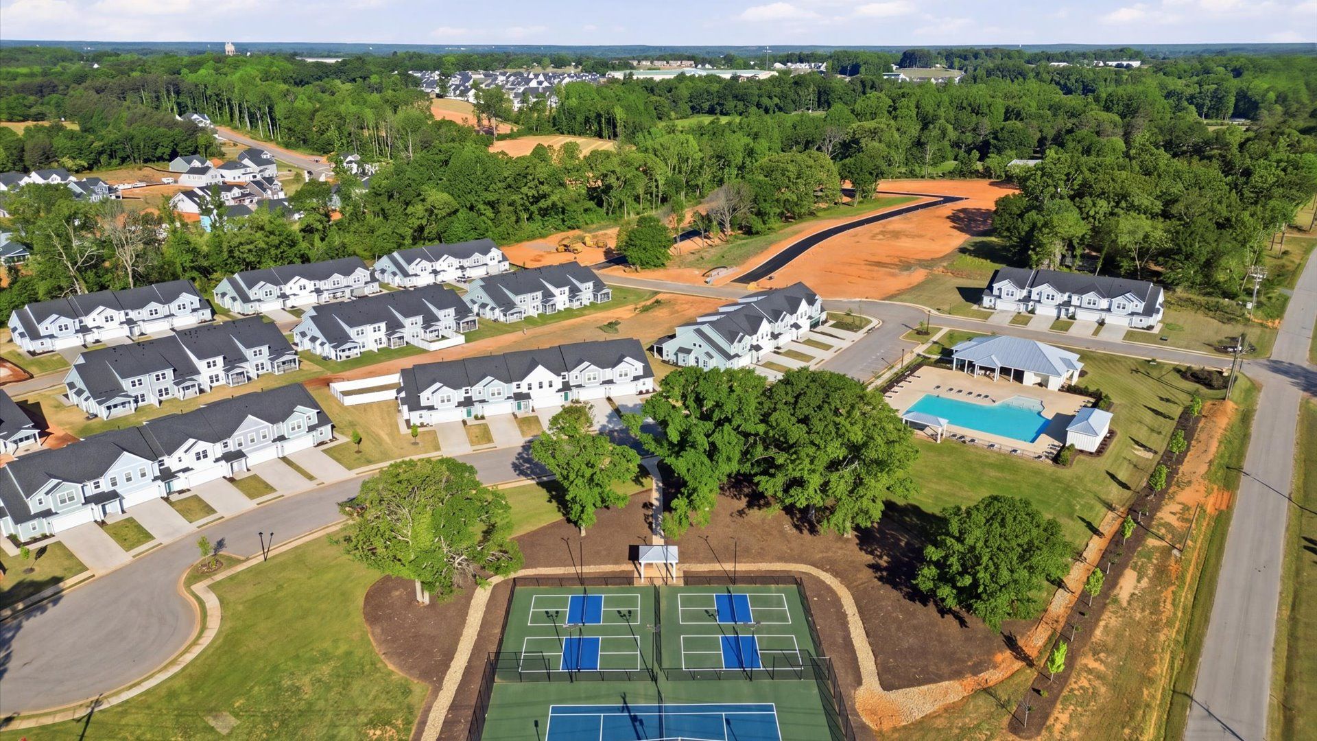 Large amenities center including resort style swimming pool at Village at Midway by DRB Homes