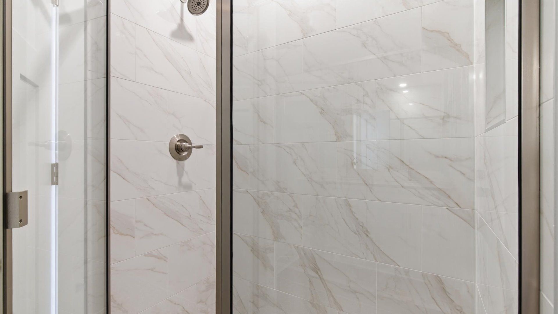 Highly functional and elegant en-suite with dual vanities, tiled walk-in shower, and refined finishes