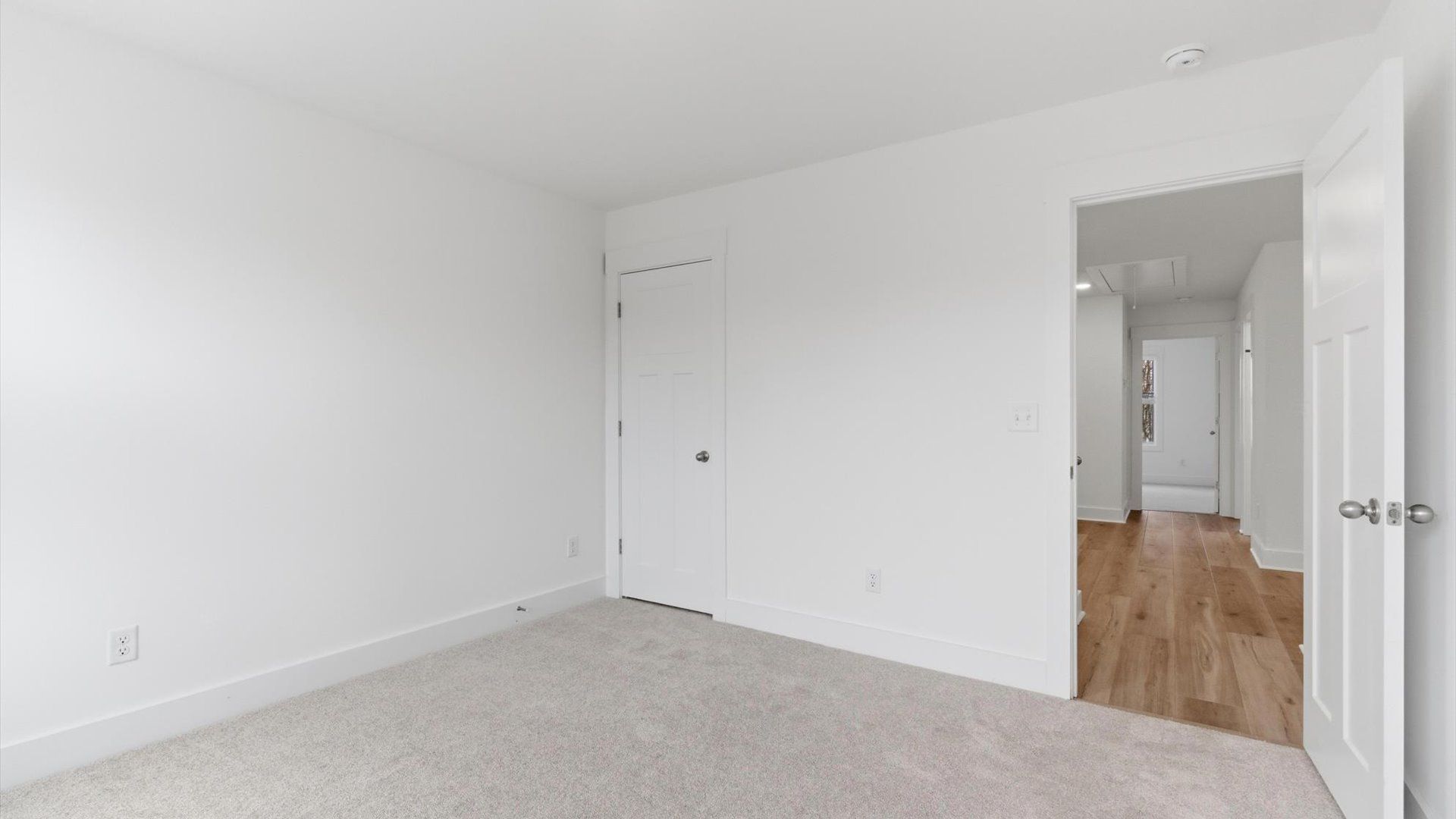 Elegant bedroom retreat featuring soft carpeting and a thoughtfully designed walk-in closet