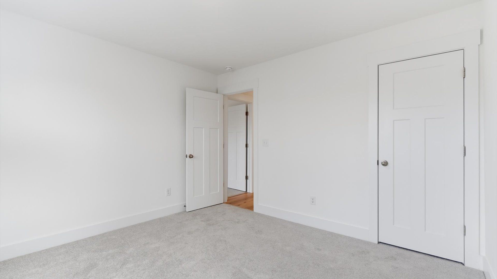 Accomplished design shines in this carpeted bedroom with a functional walk-in closet