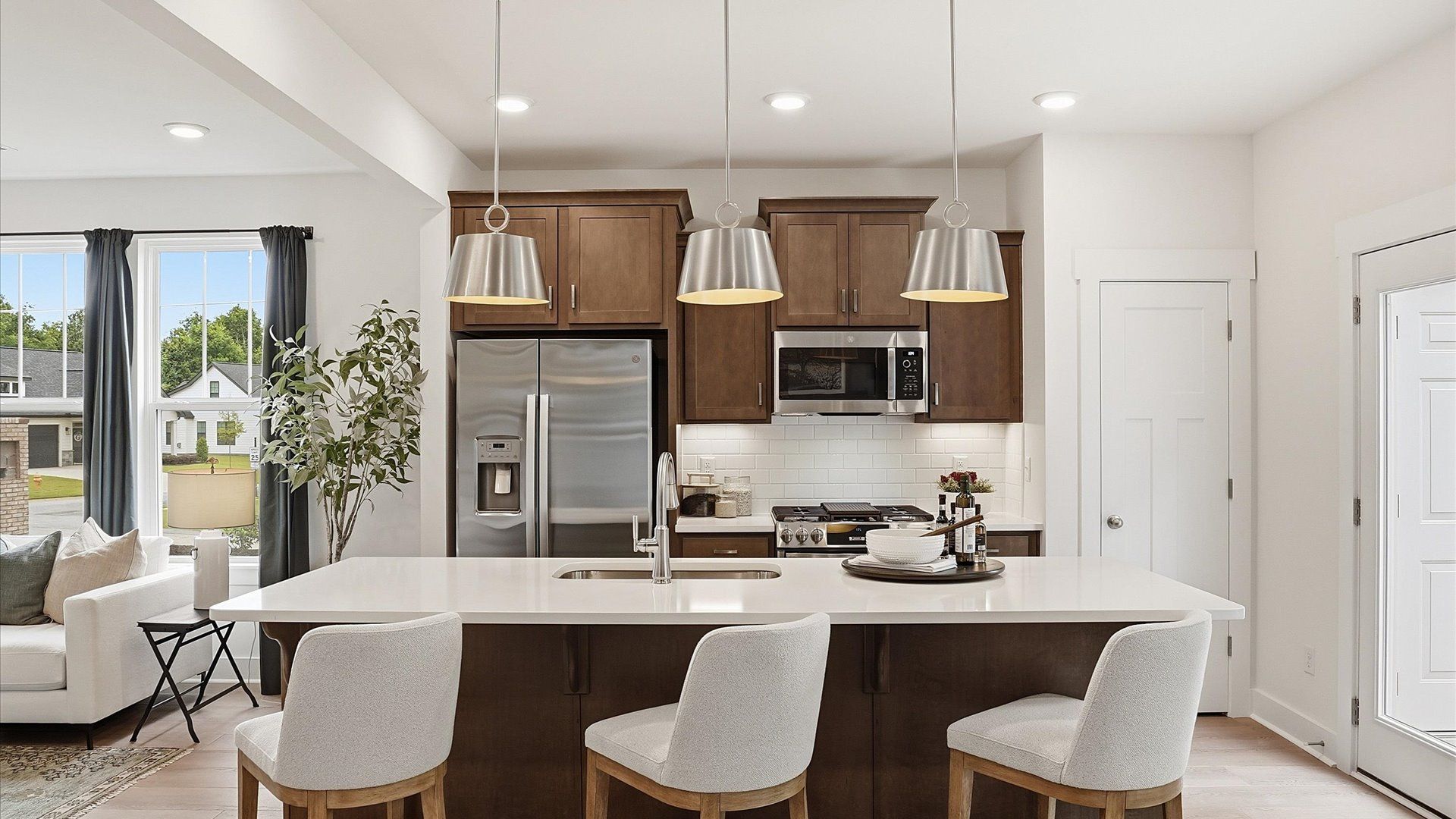Highly skilled craftsmanship shines in this modern kitchen with pendant lighting and a central island focal point