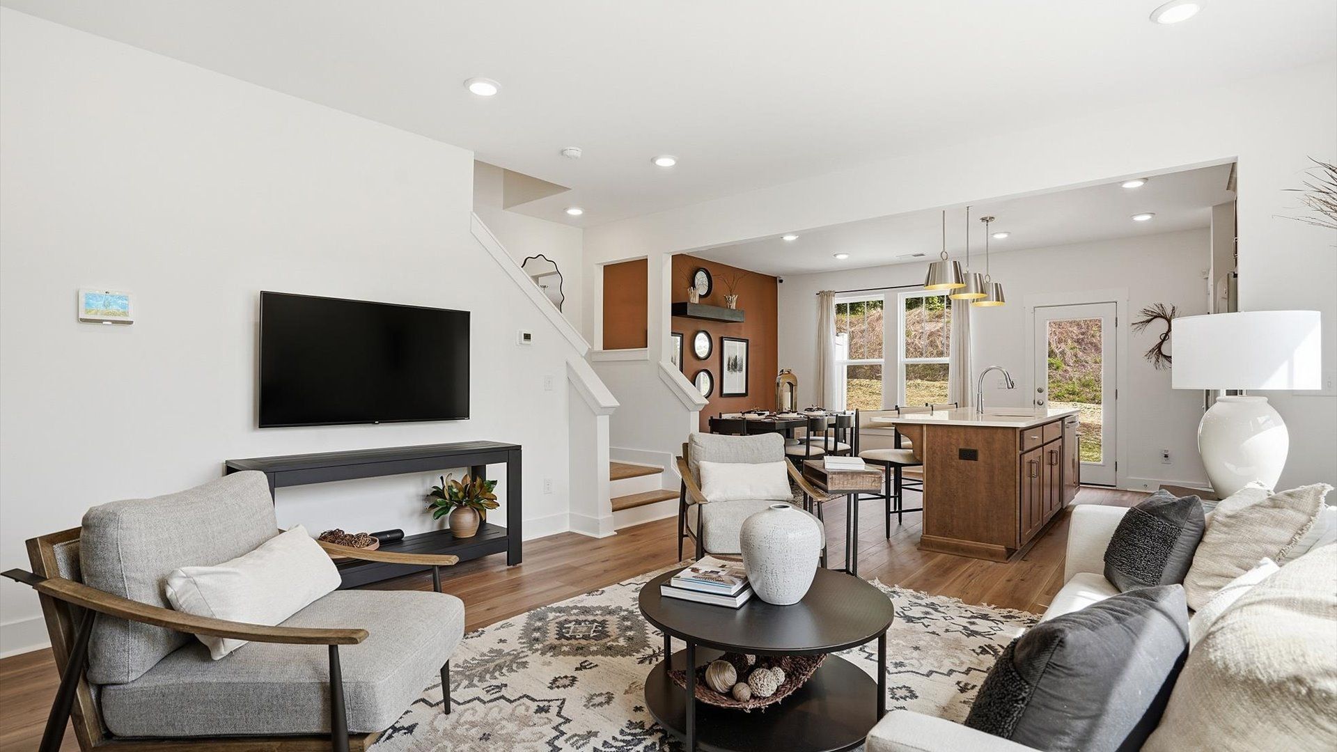 Eye-catching family room with elegant millwork and seamless access to dining and kitchen located near Downtown Greenville