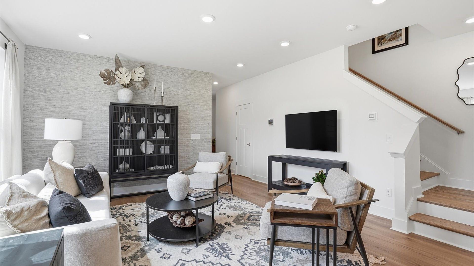Spacious family room with rich hardwood flooring and elegant trim work in a reputable DRB Homes build