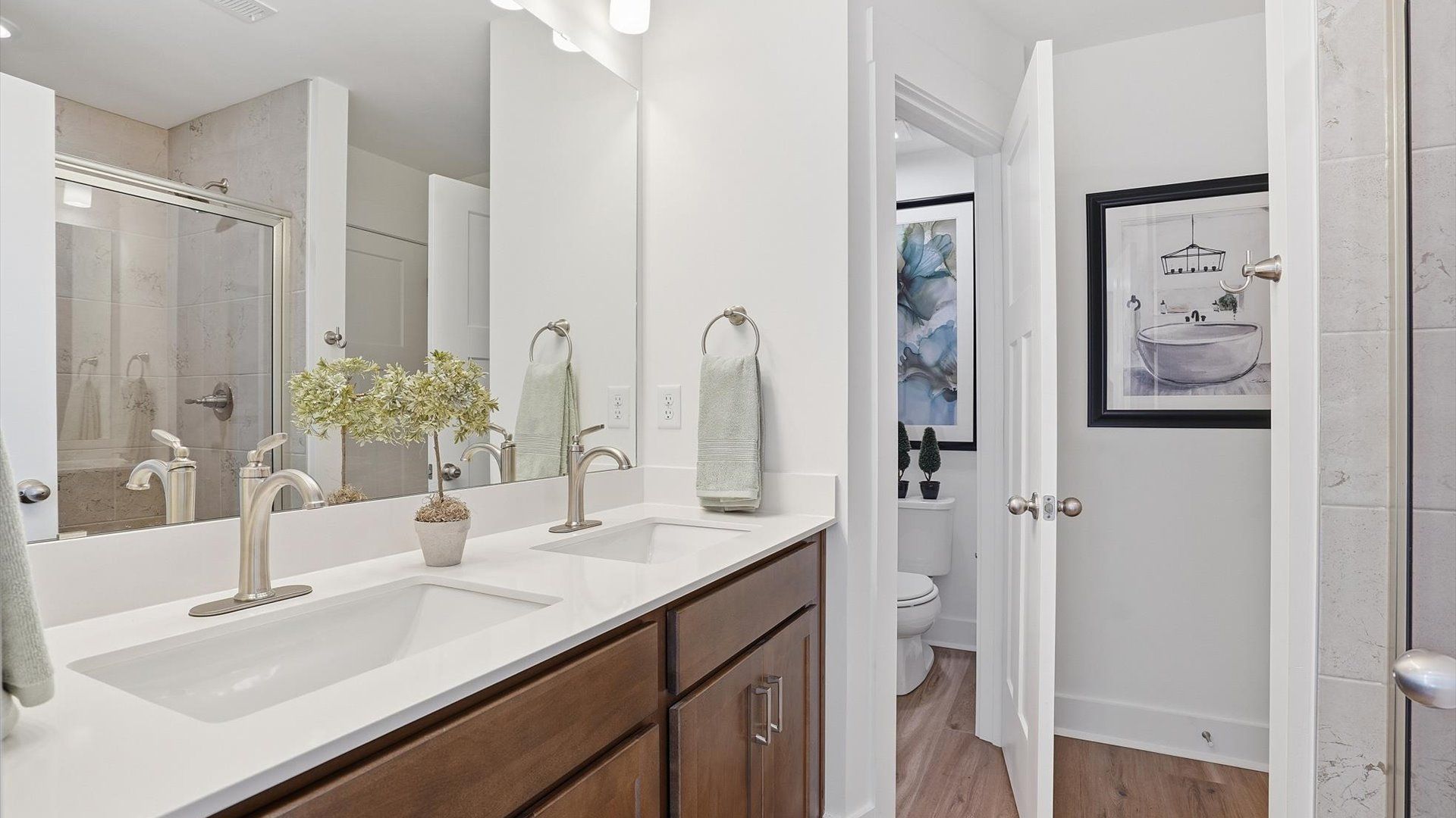 Notable primary bath featuring dual vanity, walk-in shower, and tasteful design touches throughout at Marion Square