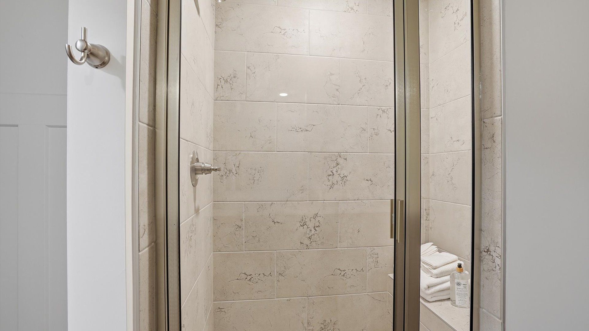 Memorable mornings begin in this elegant primary bathroom with a tiled walk-in shower and modern features in Greenville, SC
