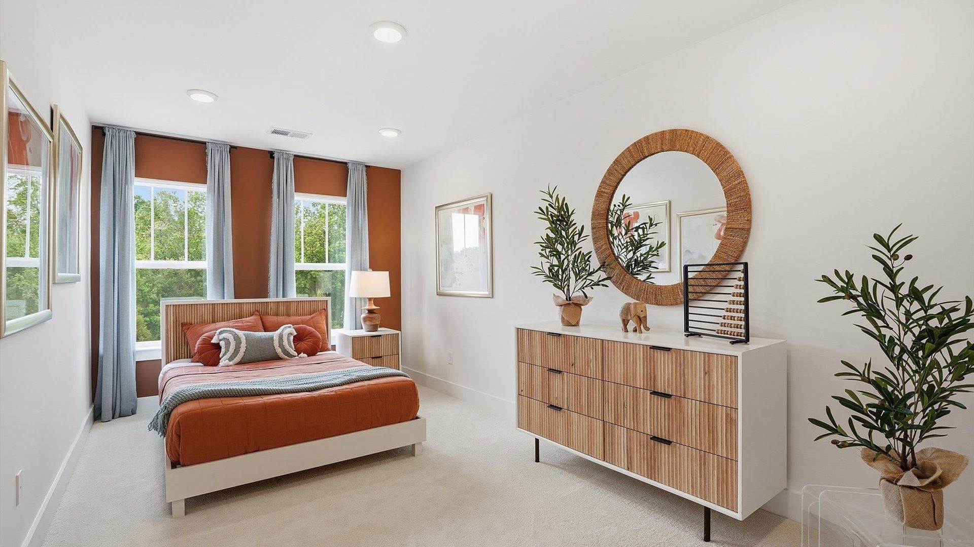 Tasteful bedroom with plush carpet, a walk-in closet, and large windows for abundant natural light at Marion Square