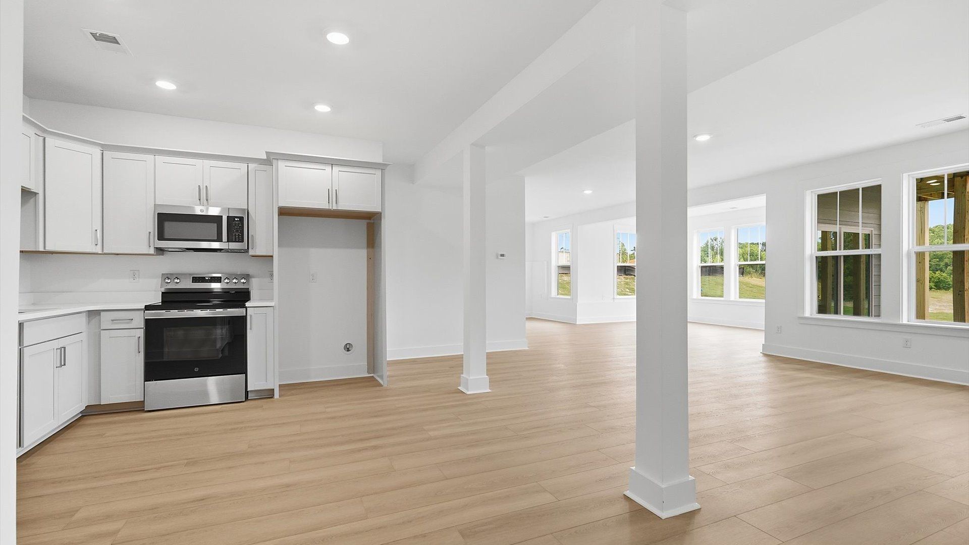 Highly skilled design choices create a clean, open kitchen located in the basement at the Pinebrook community