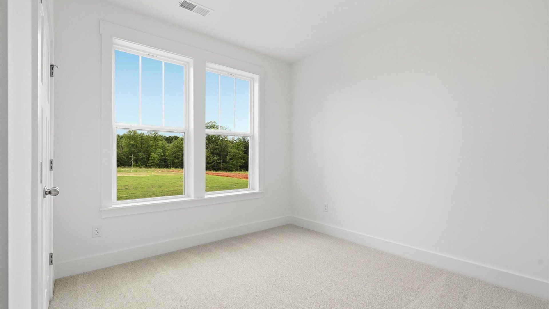 Notable secondary bedroom offering cozy carpeted flooring and a stylish walk-in closet located in Woodruff, SC