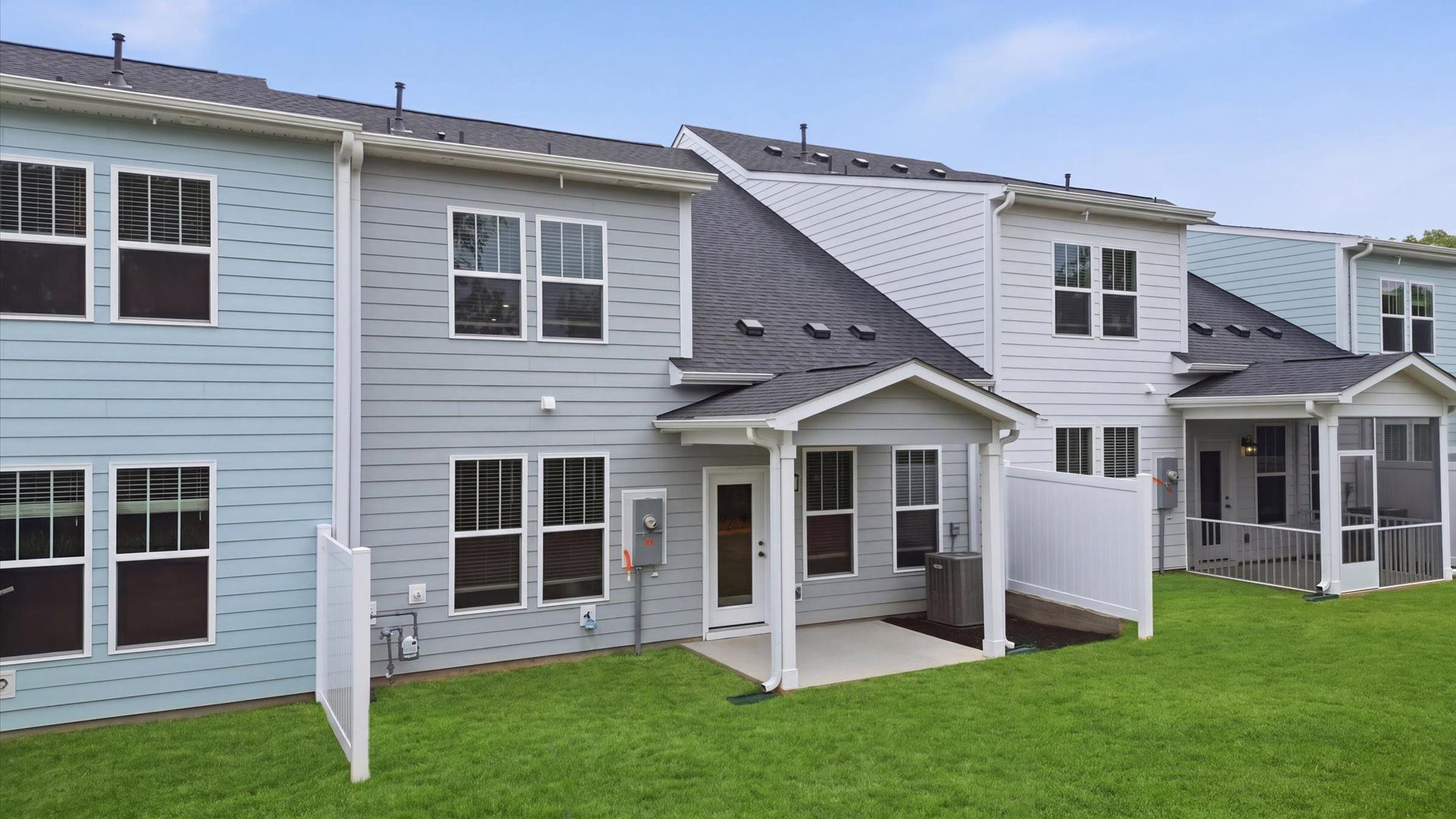 Warm and inviting outdoor living space with a covered rear porch and tasteful finishes at the Village at Midway community