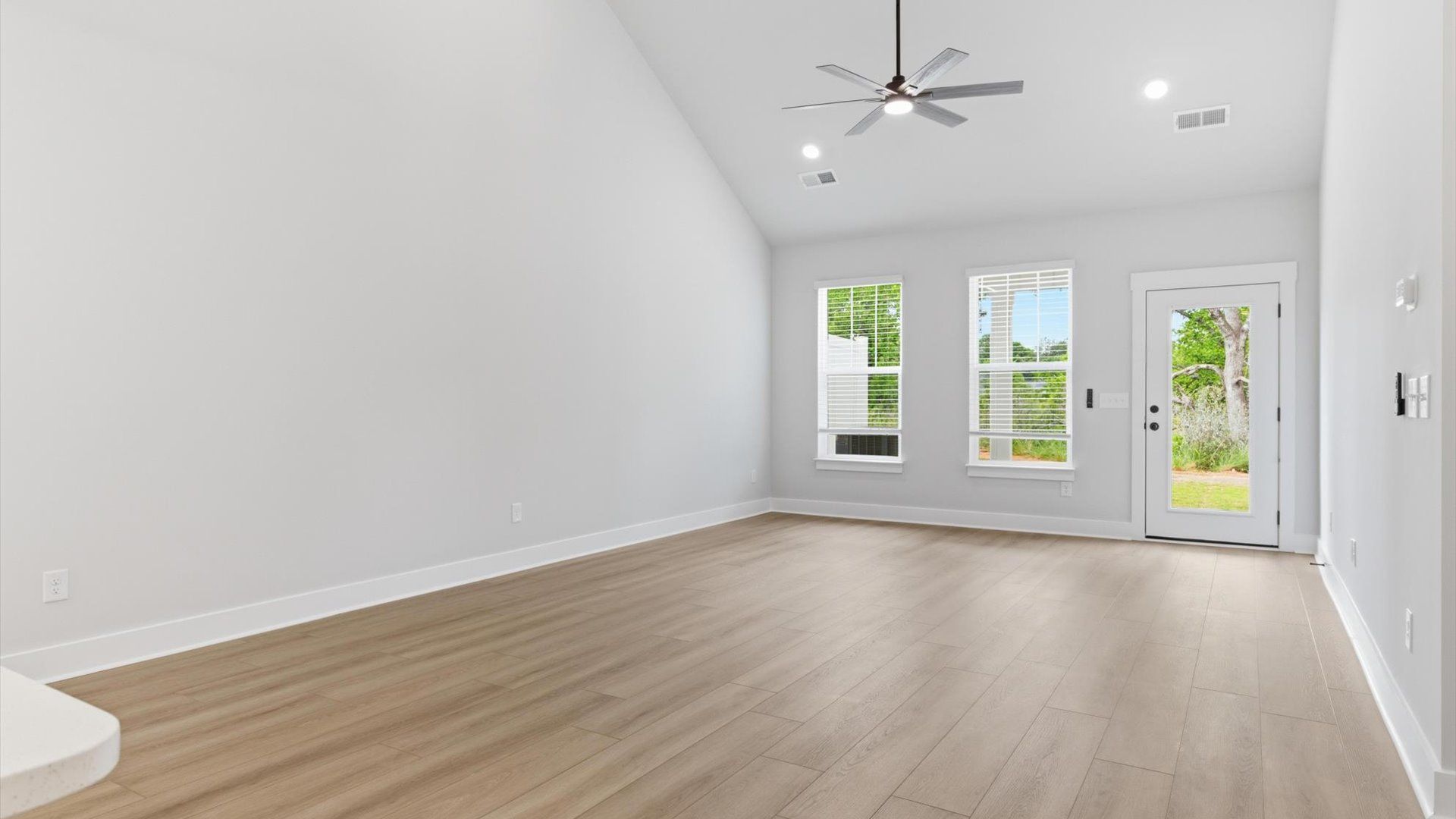 Notable two-story family room offering a grand yet inviting space for memorable everyday living at Village at Midway