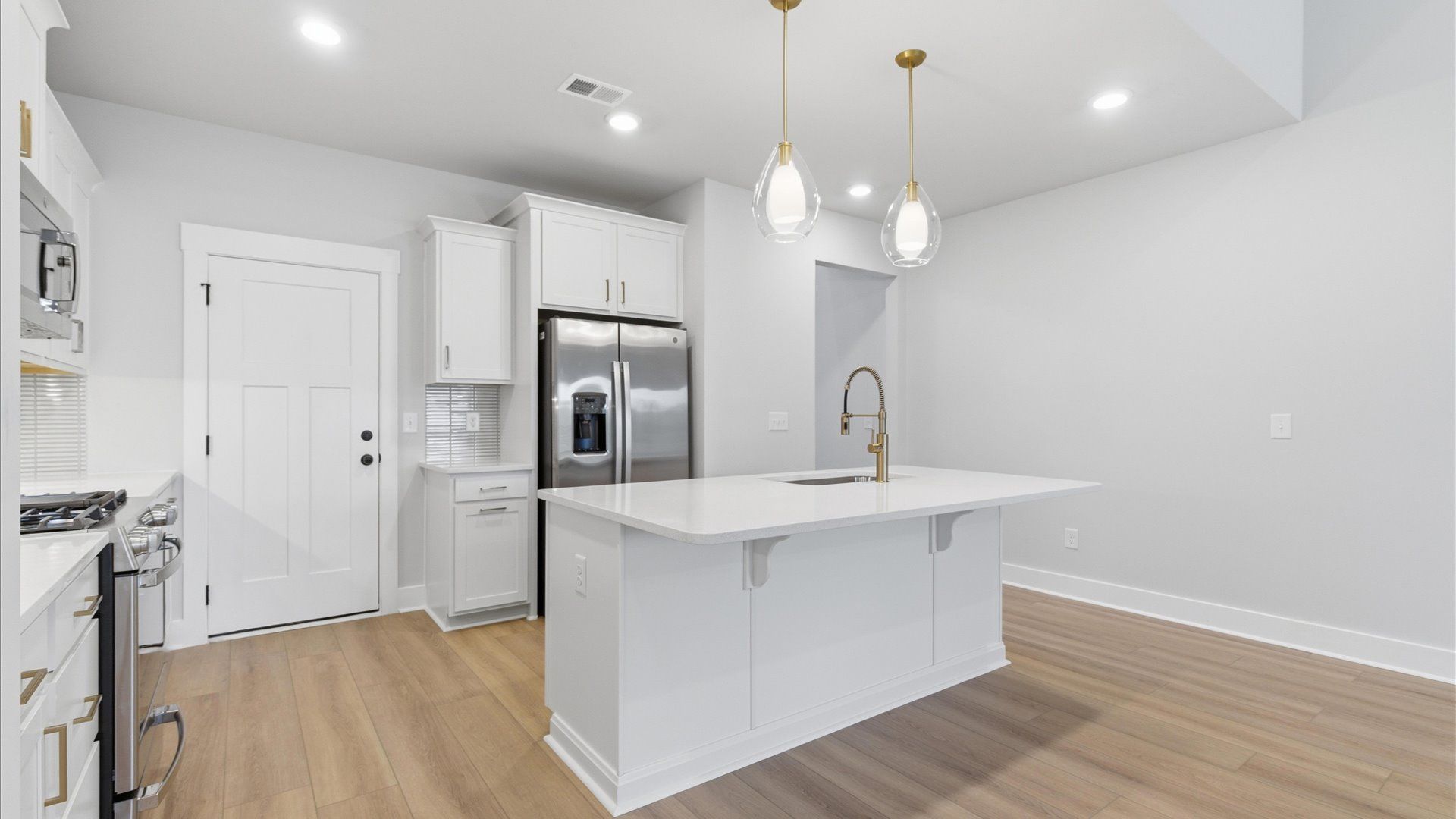 Highly skilled craftsmanship shines in this modern kitchen with pendant lighting and a central island focal point in Anderson