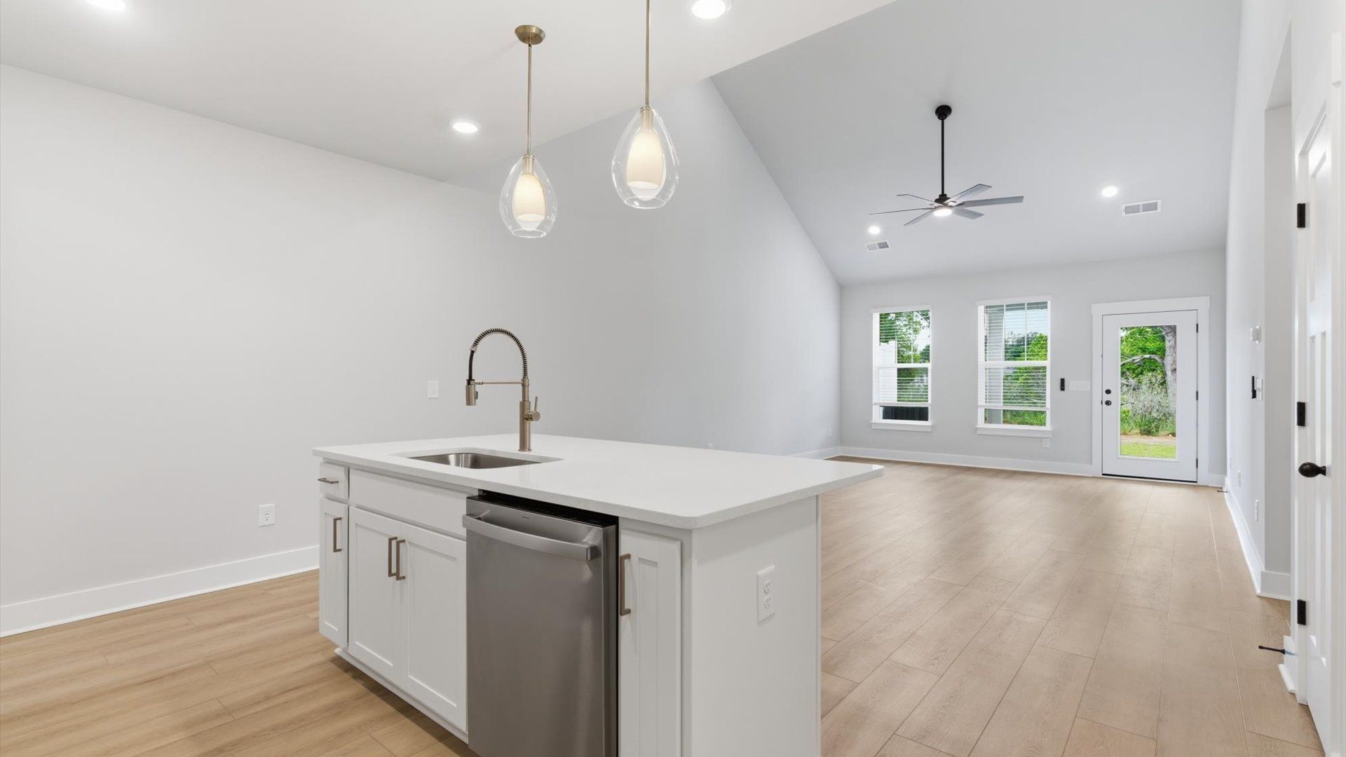 Exclusive DRB Homes kitchen with a center island, elevated finishes, and pendant lighting in a prime location