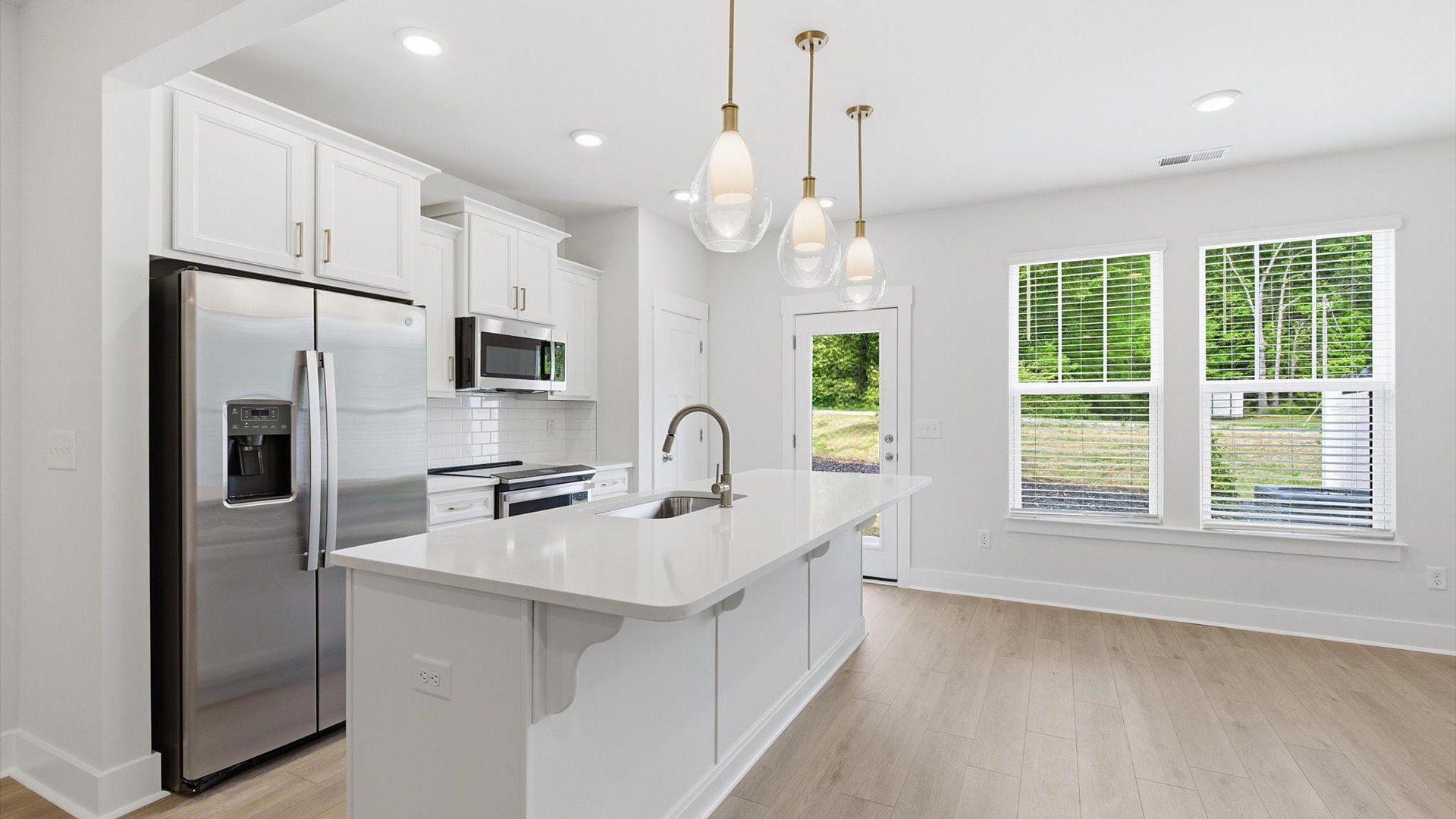 Accomplished design in a kitchen that blends function and form with a right-sized island located at Gresham Station