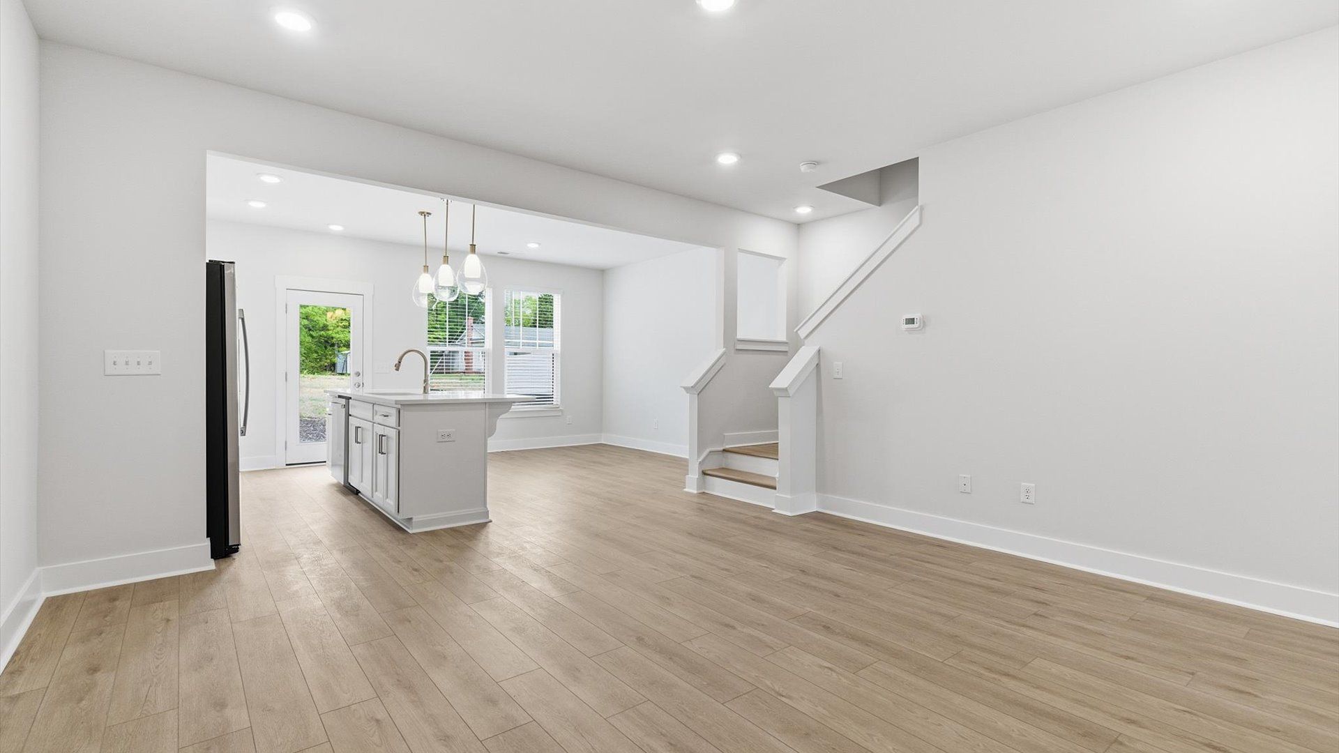 Memorable moments begin in this elegant, open family room with hardwood flooring and refined finishes in Simpsonville, SC