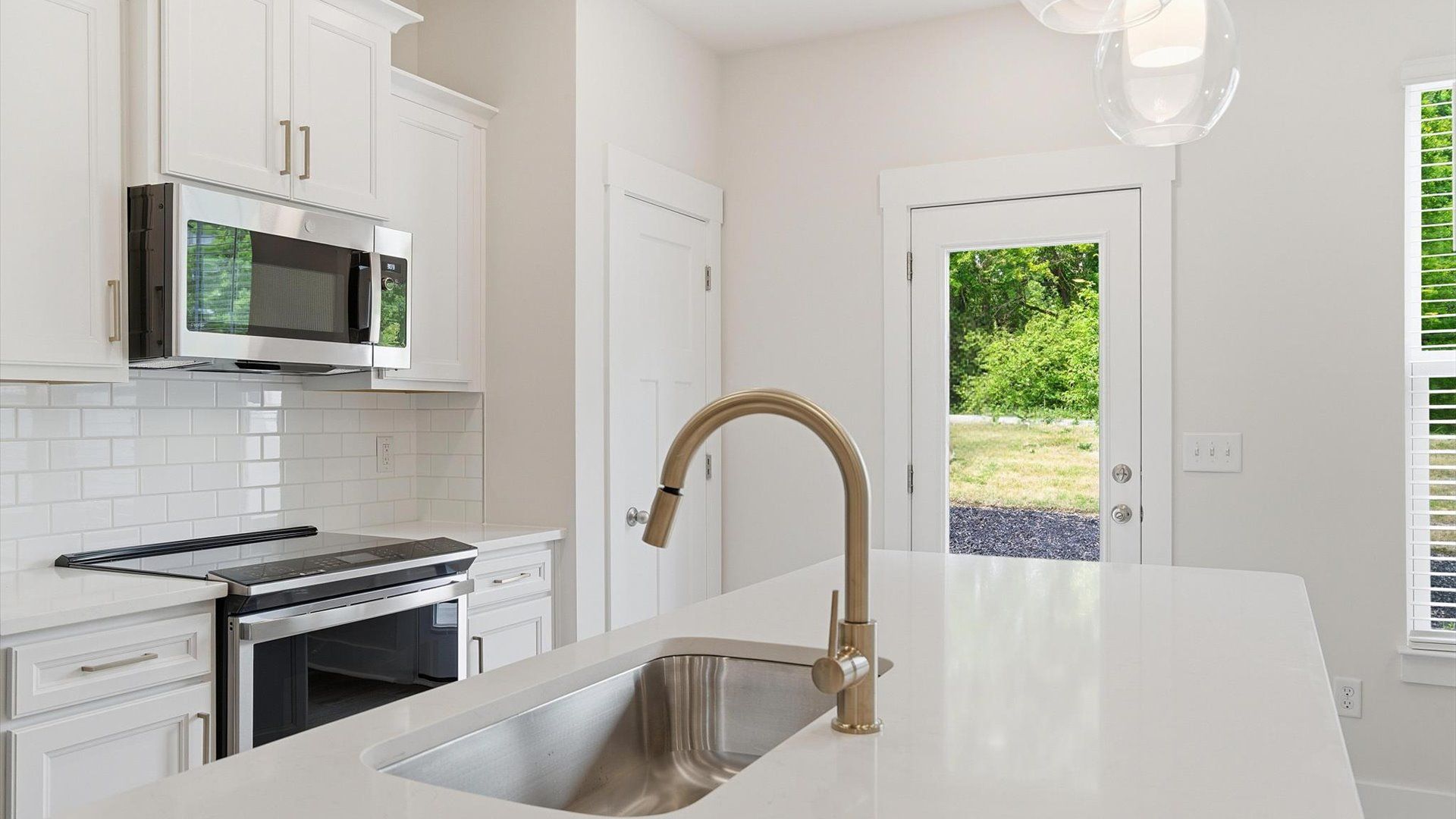 Vibrant and open kitchen centered around a center island with elegant pendant lighting above located in Simpsonville, SC
