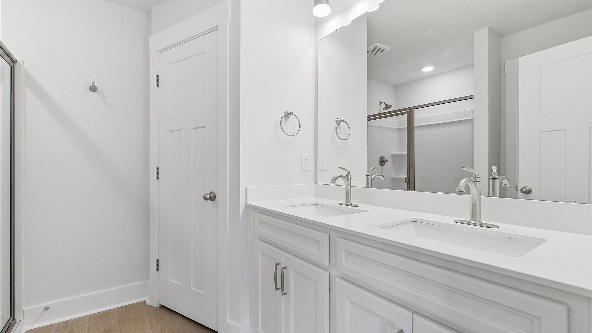 Highly functional and elegant en-suite with dual vanities, tiled walk-in shower, and refined finishes at Gresham Station