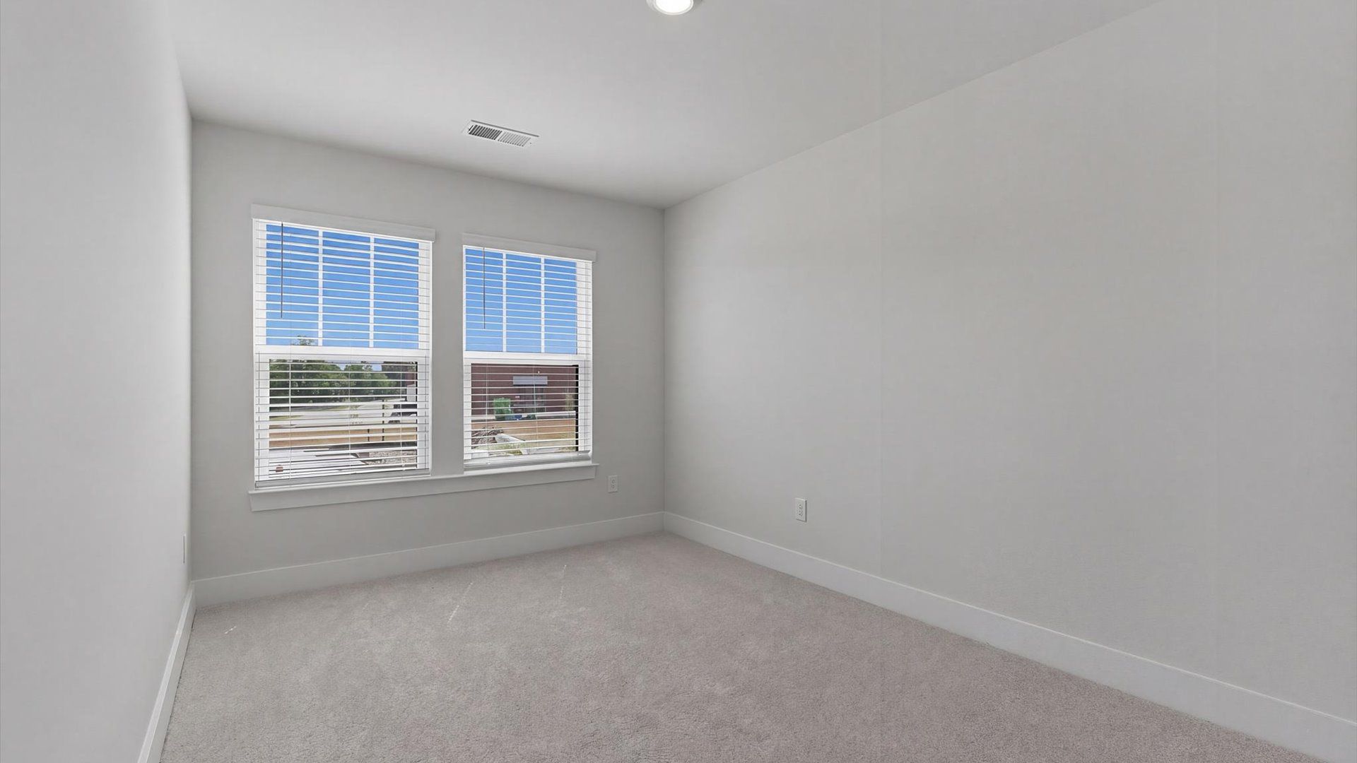 Memorable space with walk-in closet, soft carpeting, and striking natural light from large windows