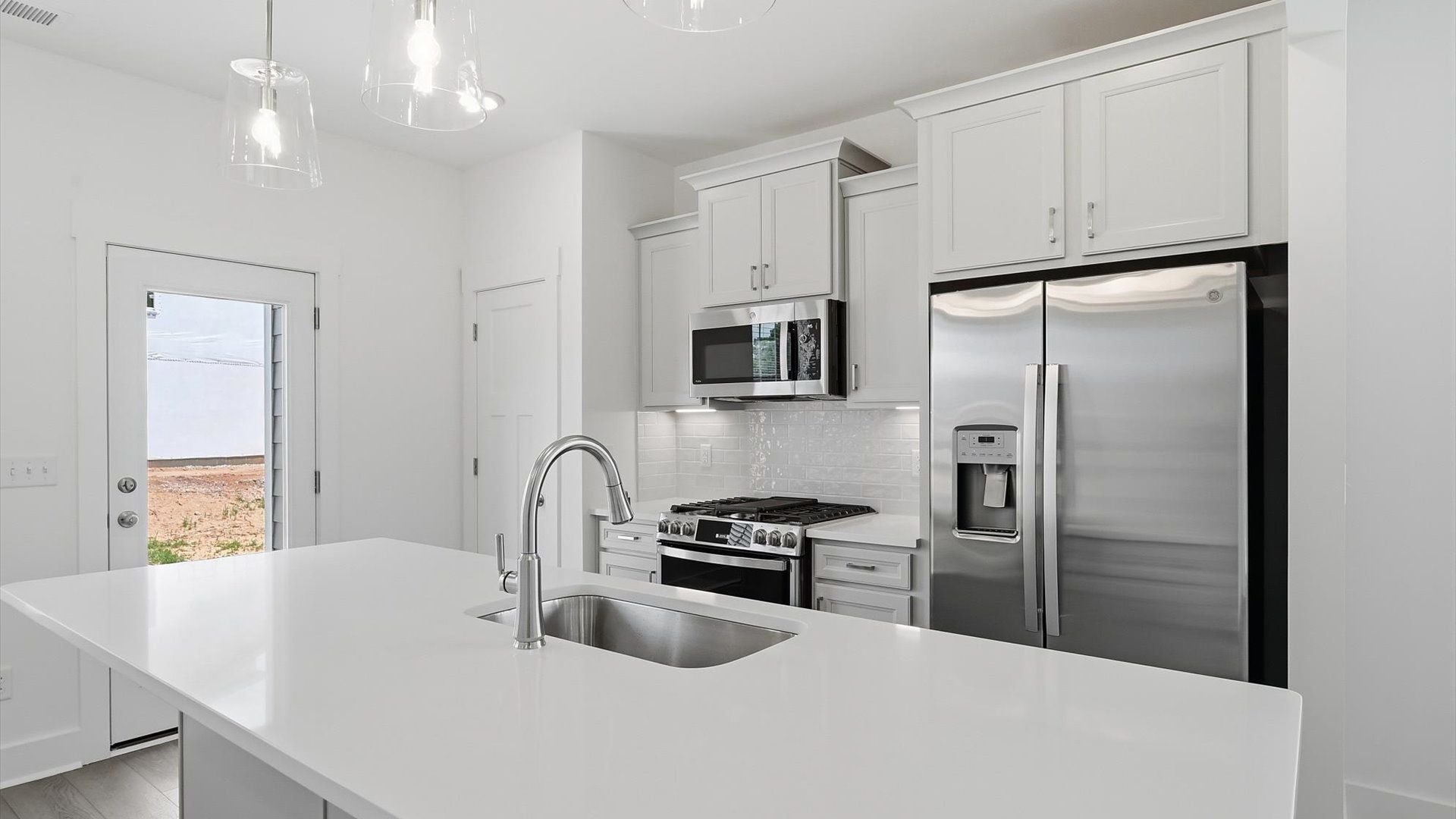 Superior craftsmanship shines in this modern kitchen with a space-saving island and open flow