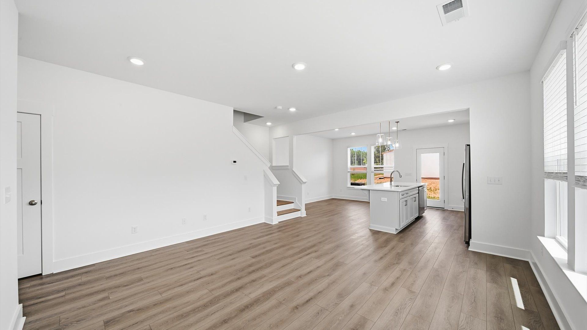 Eye-catching family room with elegant millwork and seamless access to dining and kitchen in Fountain Inn, SC