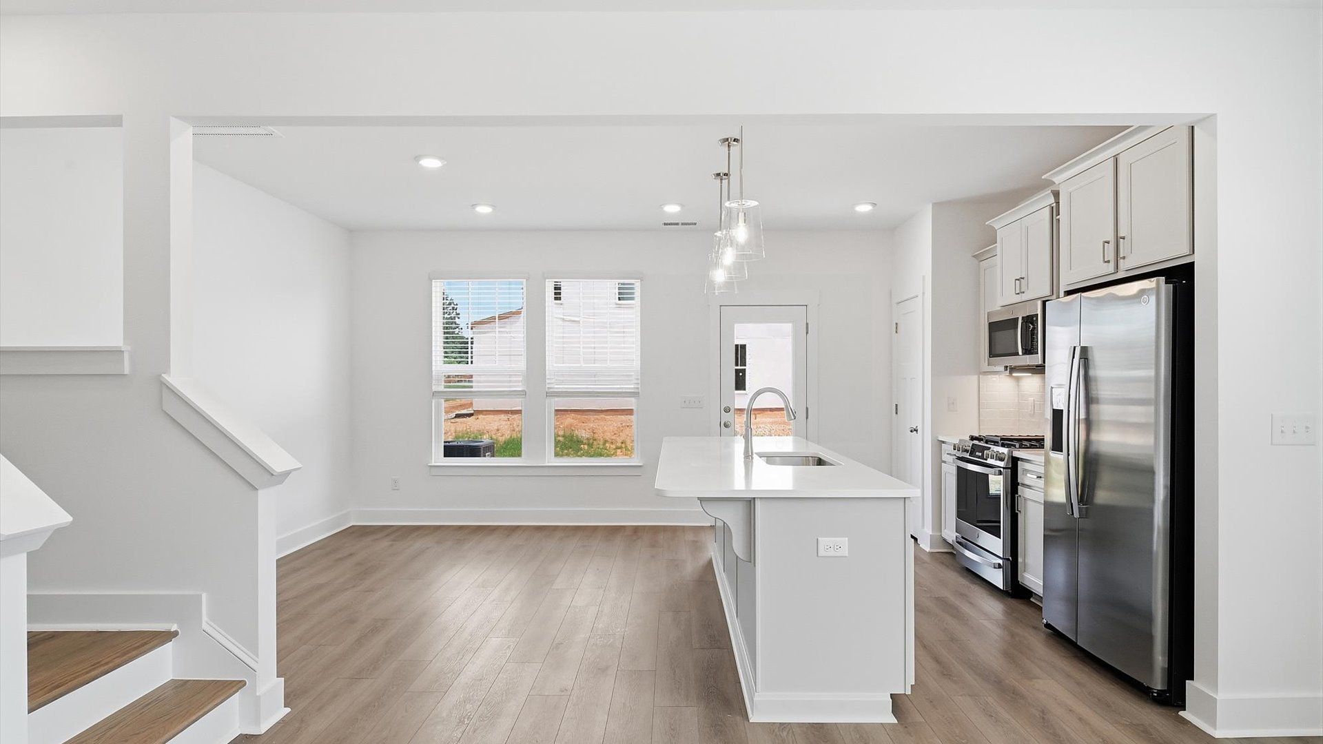 Memorable meals begin in this vibrant kitchen with pendant lighting and a thoughtfully designed island at Barton Hollow