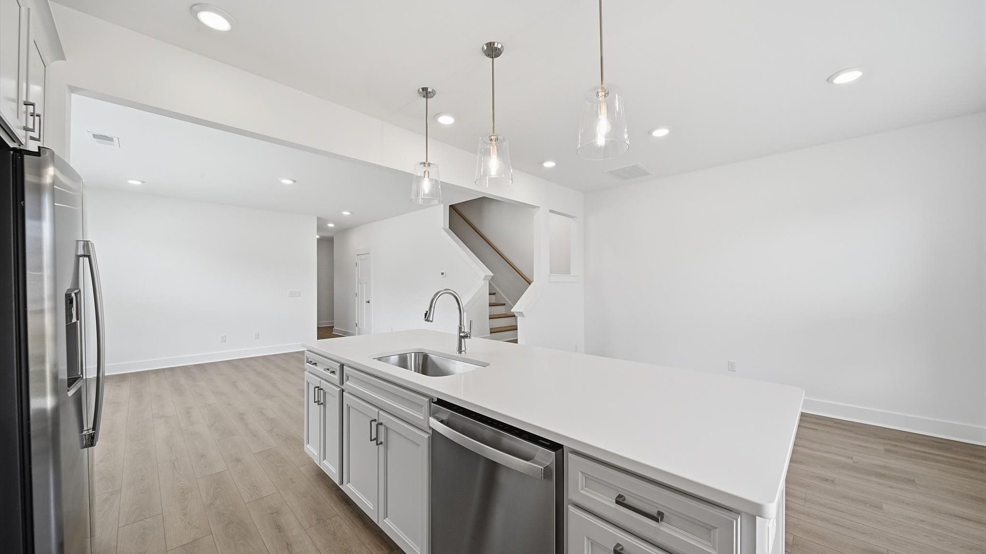 Tasteful kitchen with a streamlined island and modern finishes in a first-class DRB Homes design