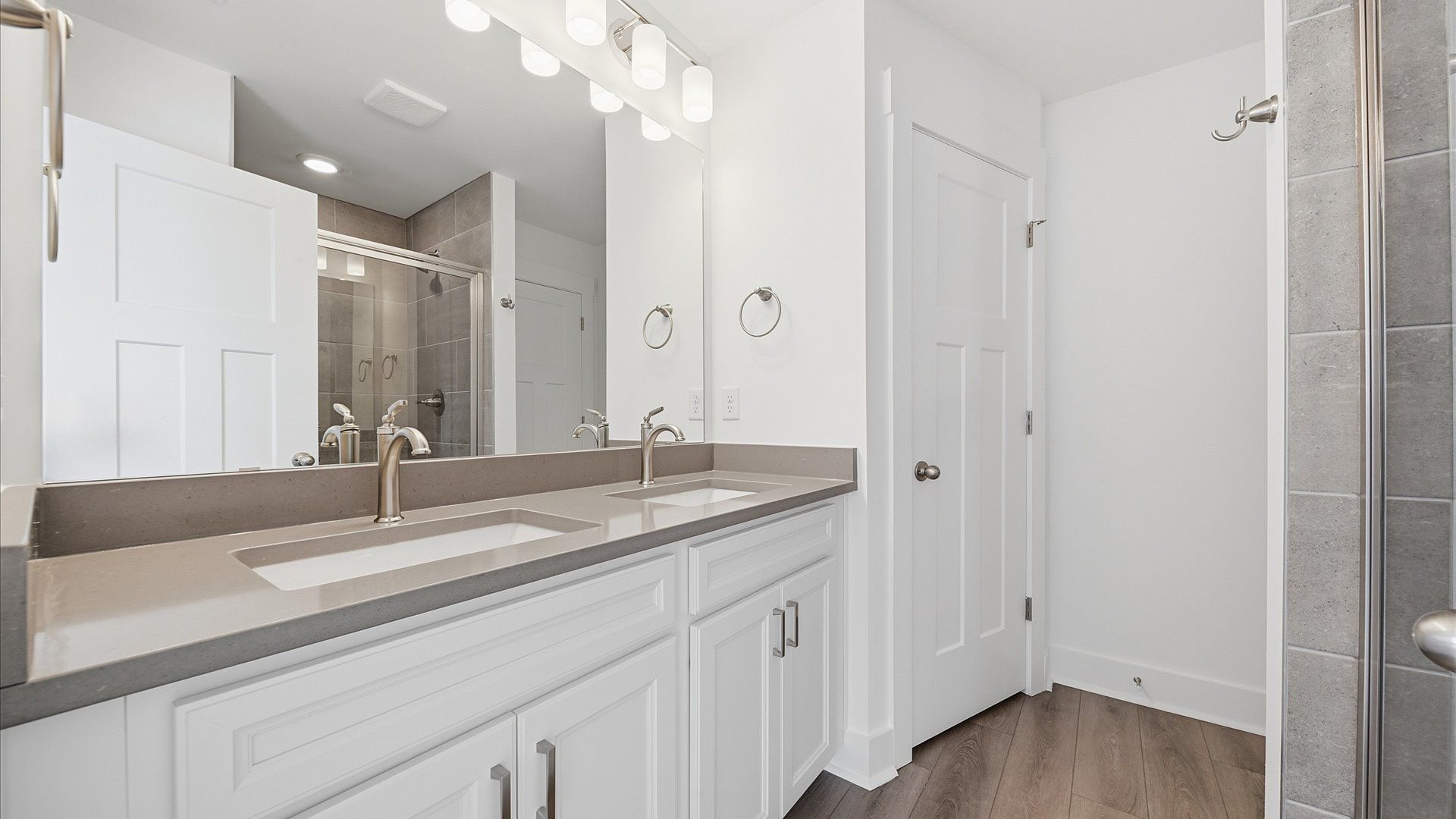Notable primary suite with dual vanities and walk-in shower in this prime Fountain Inn villa