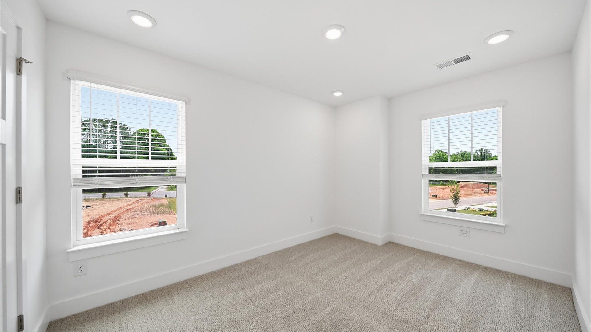 Notable bedroom offering soft carpet, a walk-in closet, and expansive windows overlooking the yard at Barton Hollow