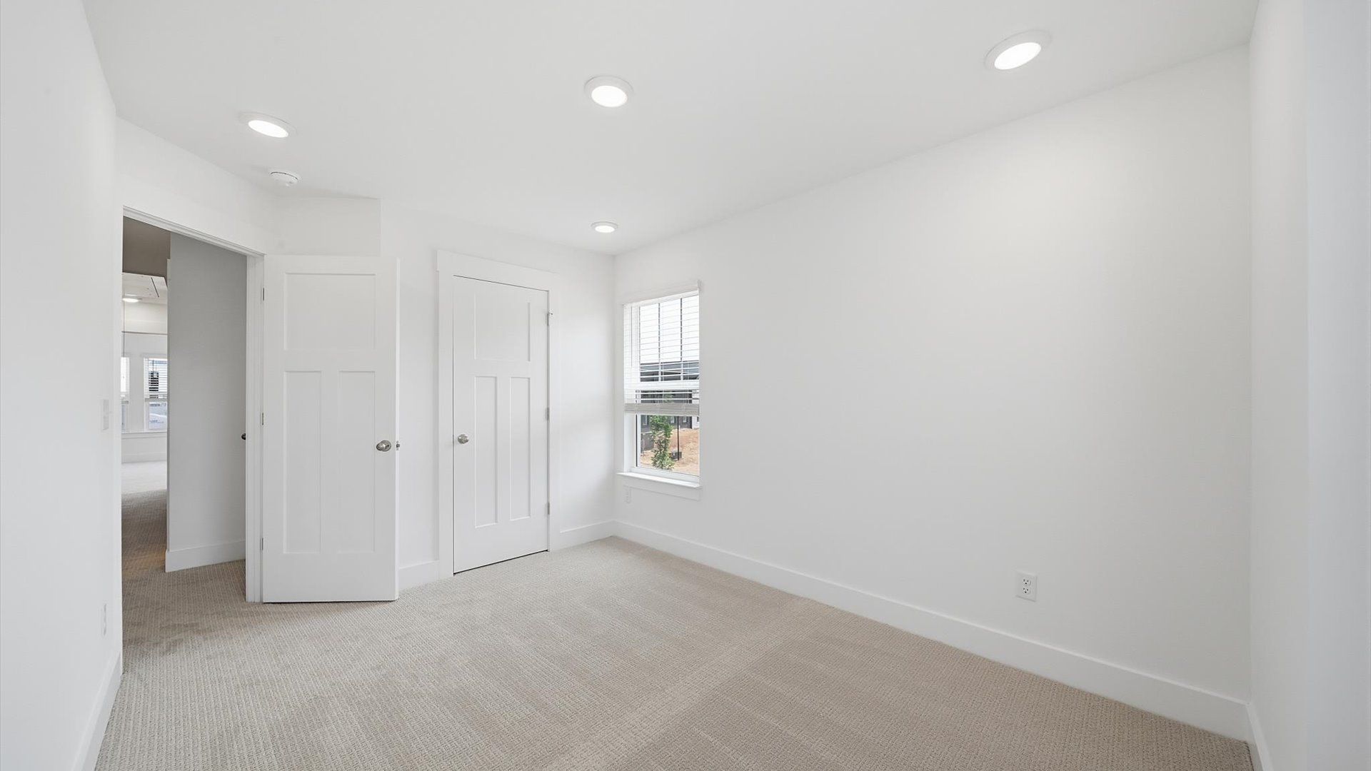 Vibrant and restful bedroom with oversized windows, refined detail, and a warm, welcoming atmosphere