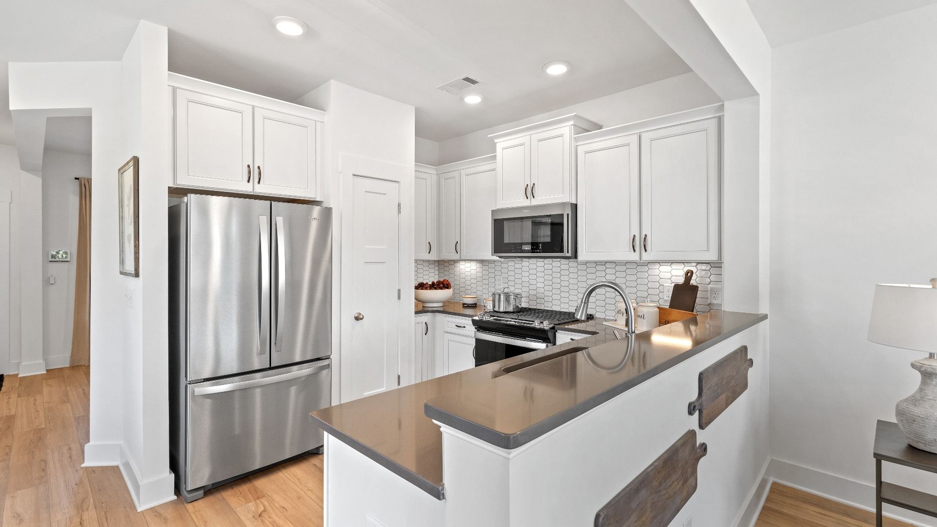 Well-designed kitchen of The Churchill Design with a center island and tasteful finishes that elevate everyday living