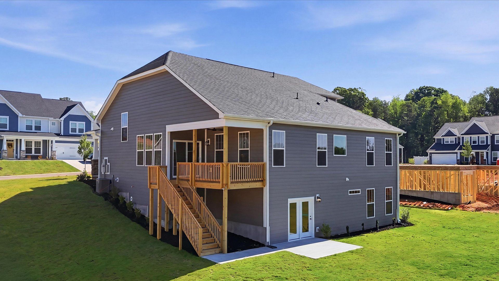 Exclusive rear covered porch and deck with accomplished detail and elevated outdoor living potential in Woodruff, SC