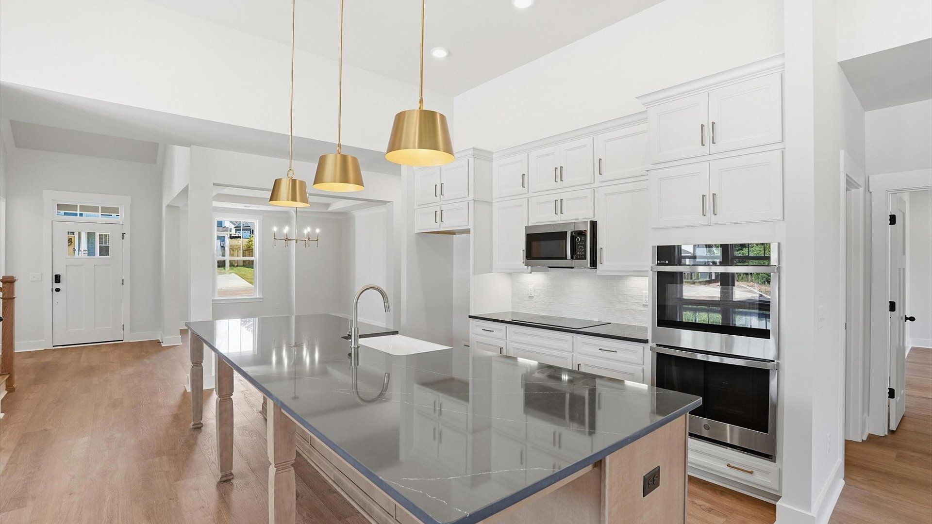 Exceptional kitchen featuring a spacious island, eye-catching pendant lights, and modern finishes at Pinebrook