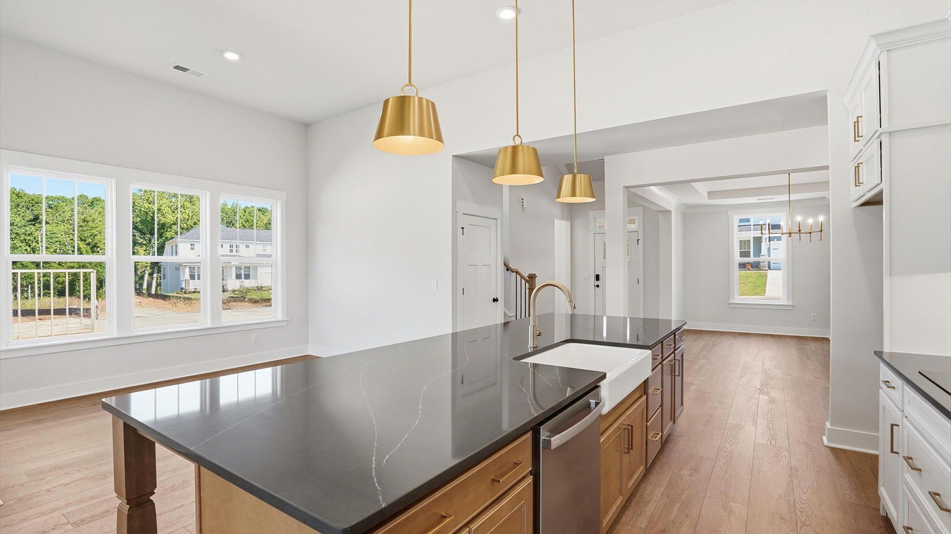 Highly skilled craftsmanship shines in this modern kitchen with pendant lighting and a central island focal point