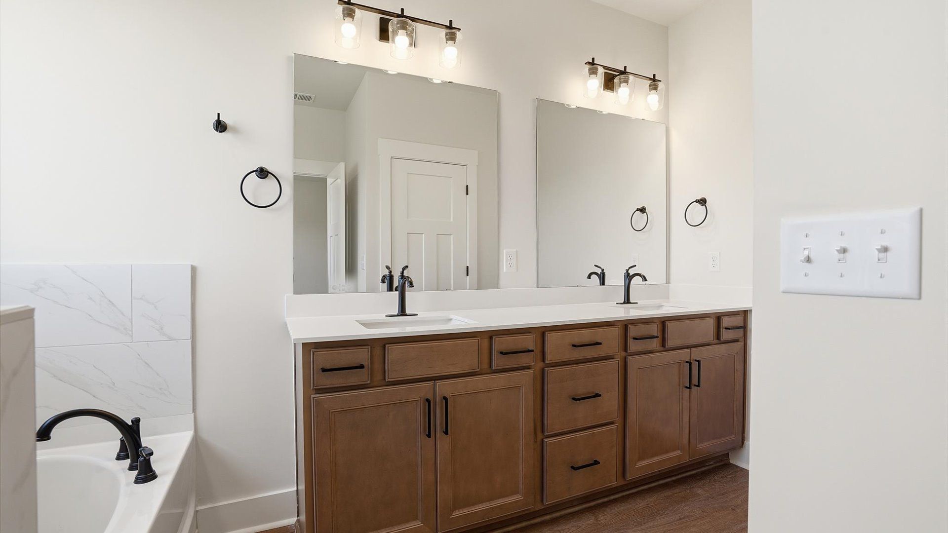Memorable mornings begin in this elegant primary bathroom with walk-in shower and double vanity located at Pinebrook