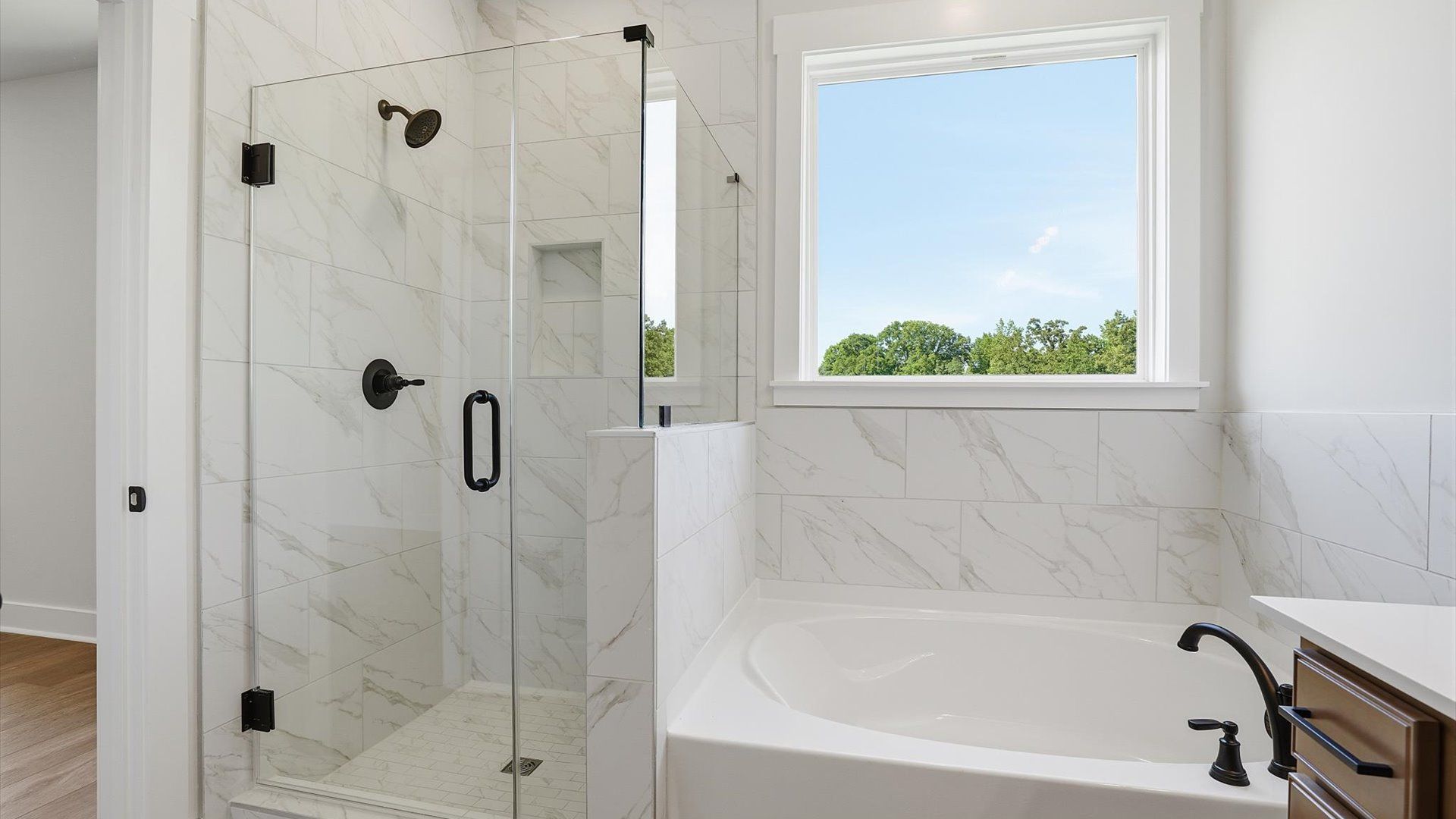 Exceptional en-suite with a soaking tub and glass-enclosed walk-in shower for superior everyday comfort in Woodruff, SC